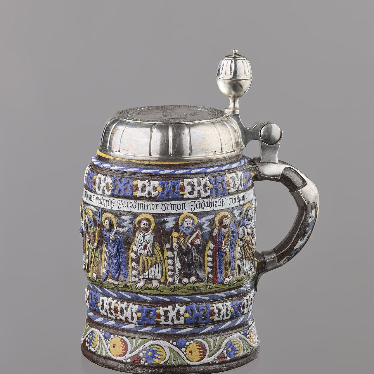 An ornate antique beer stein
