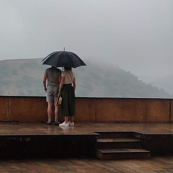 A couple under an umbrella in the rain