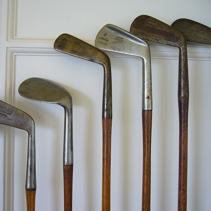 A set of antique hickory-shafted golf clubs
