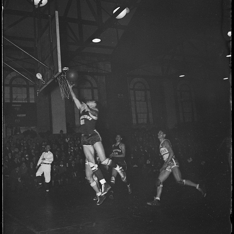 A vintage basketball game, player going up for a layup