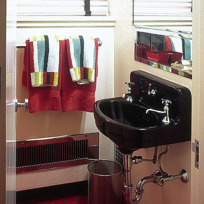 A wall-mounted sink and chrome faucet