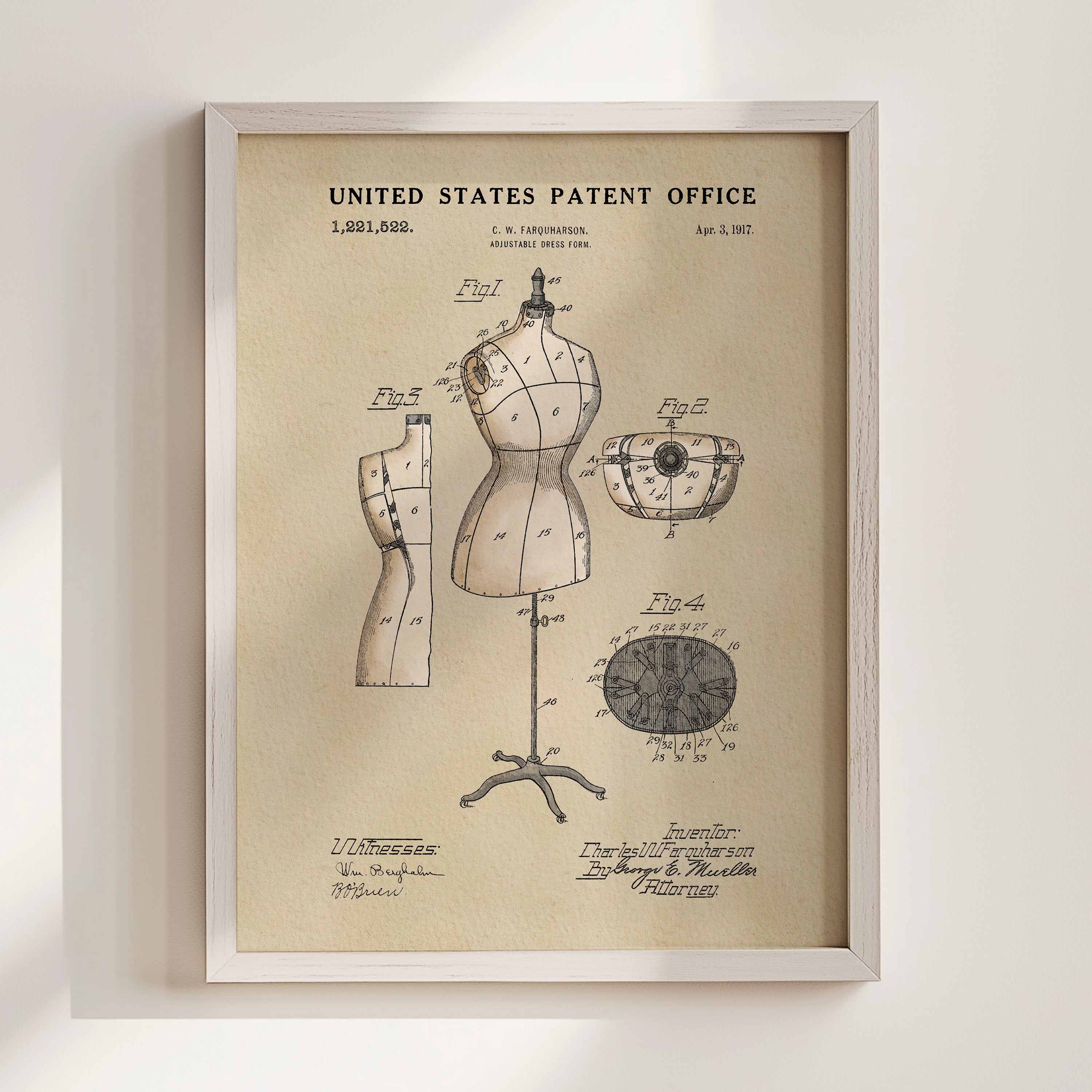 The image is a framed vintage patent drawing depicting a mannequin and various technical drawings related to fashion and clothing.