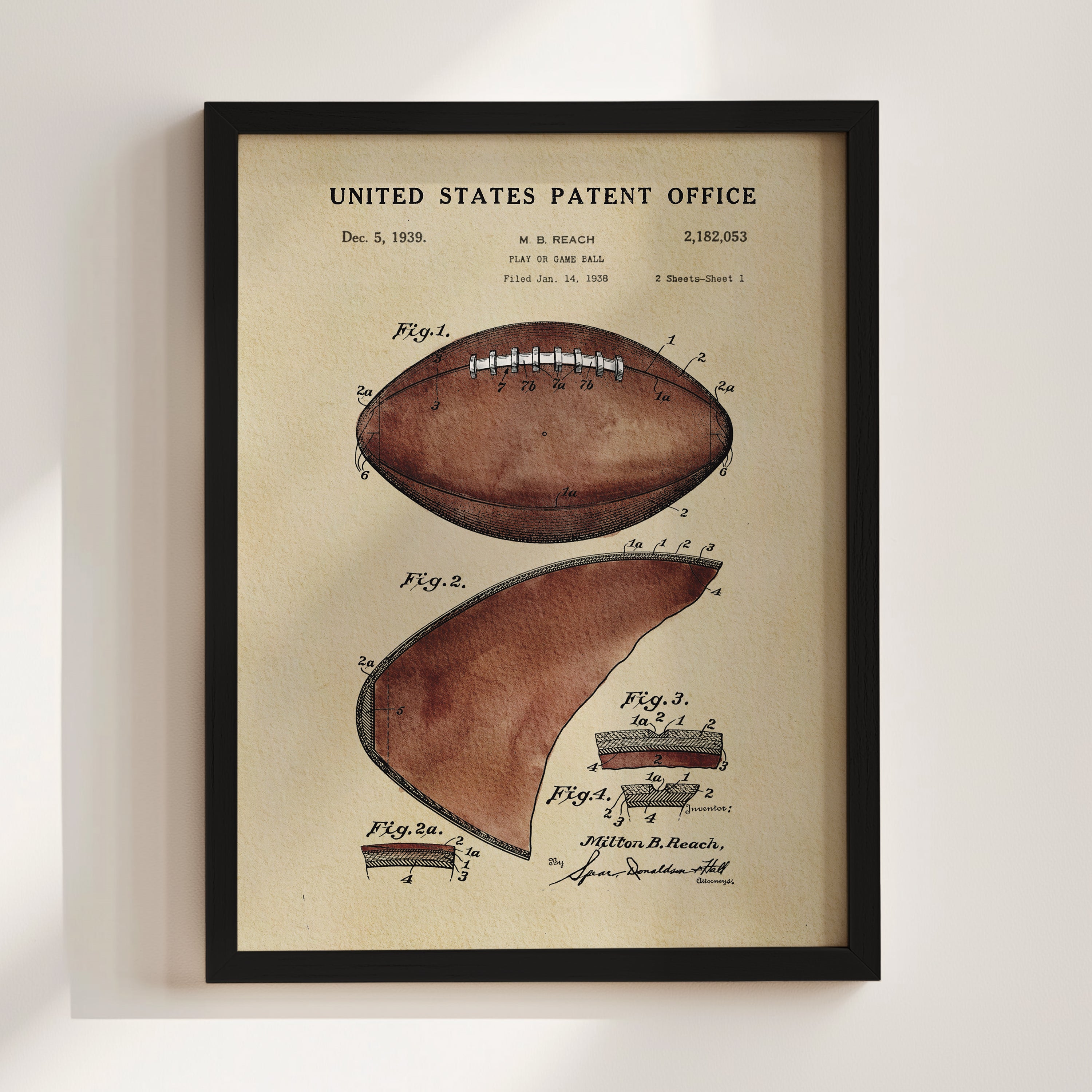The image is a framed vintage patent drawing of a football, depicting the design and features of the ball.