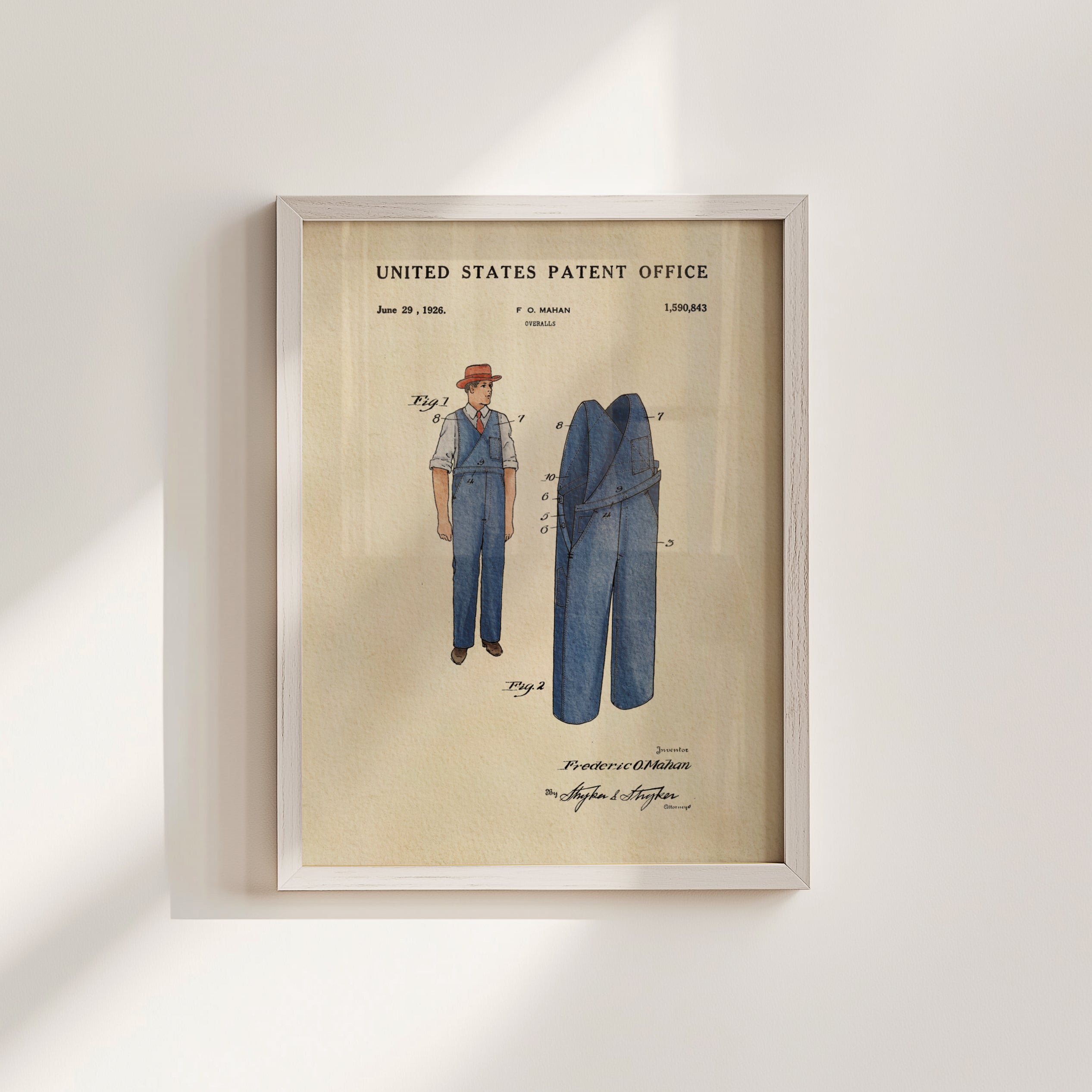 The image is a framed patent drawing depicting a man's outfit, including a hat and pants, with a title