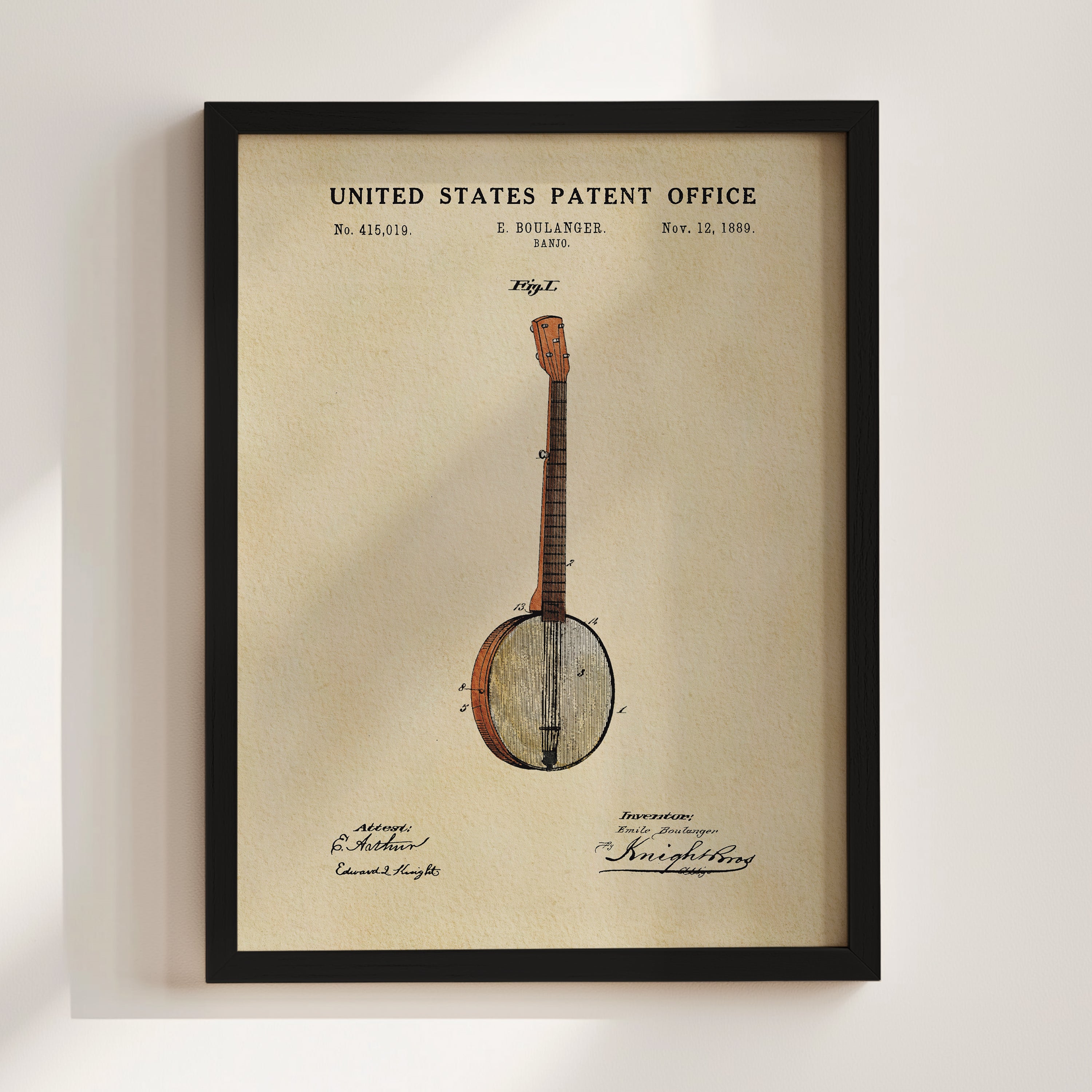 The image is a framed patent drawing of a banjo, depicting a banjo with a wooden body and a round headstock.