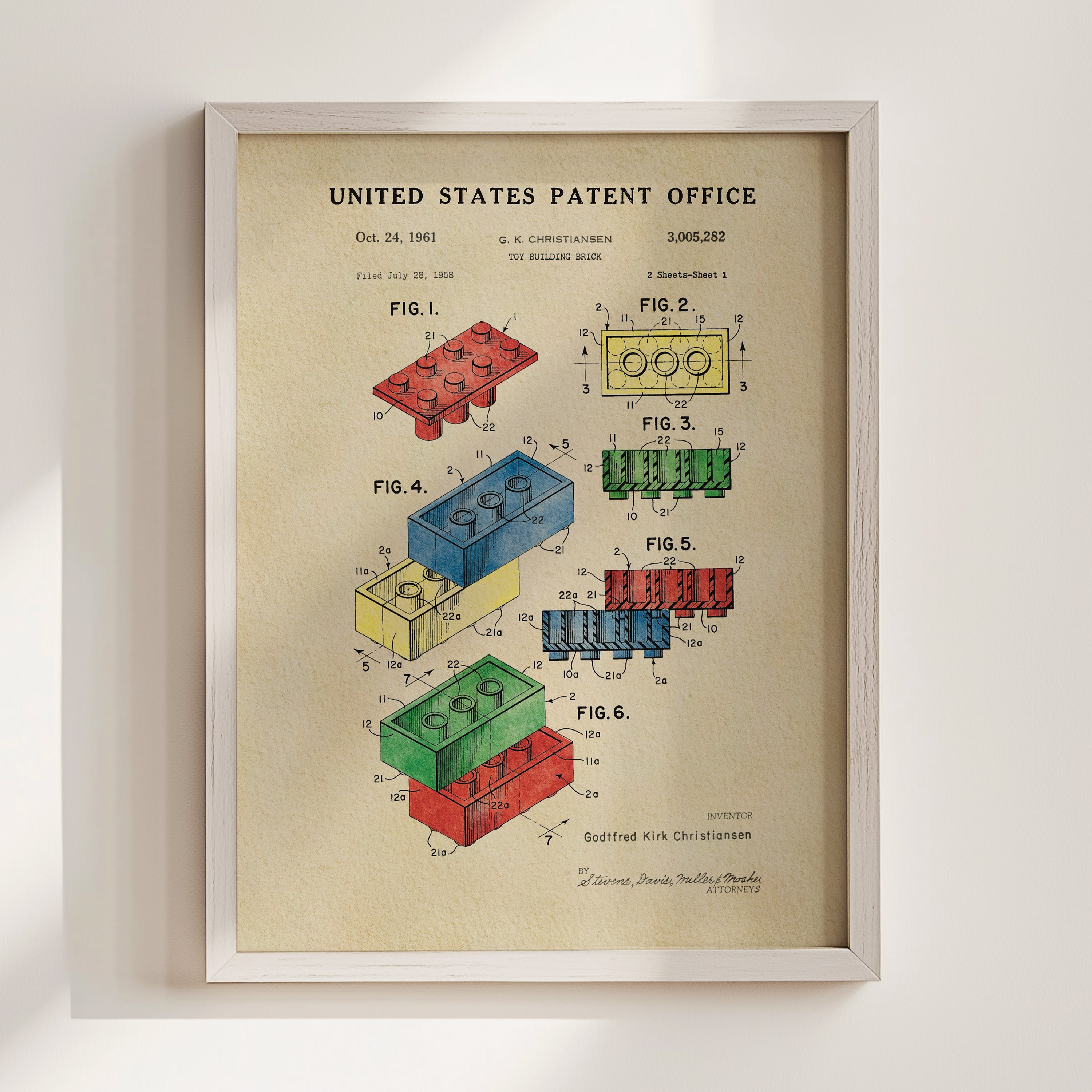 The image is a framed patent drawing depicting various Lego brick designs, including a blue brick, a red brick, and a yellow brick.