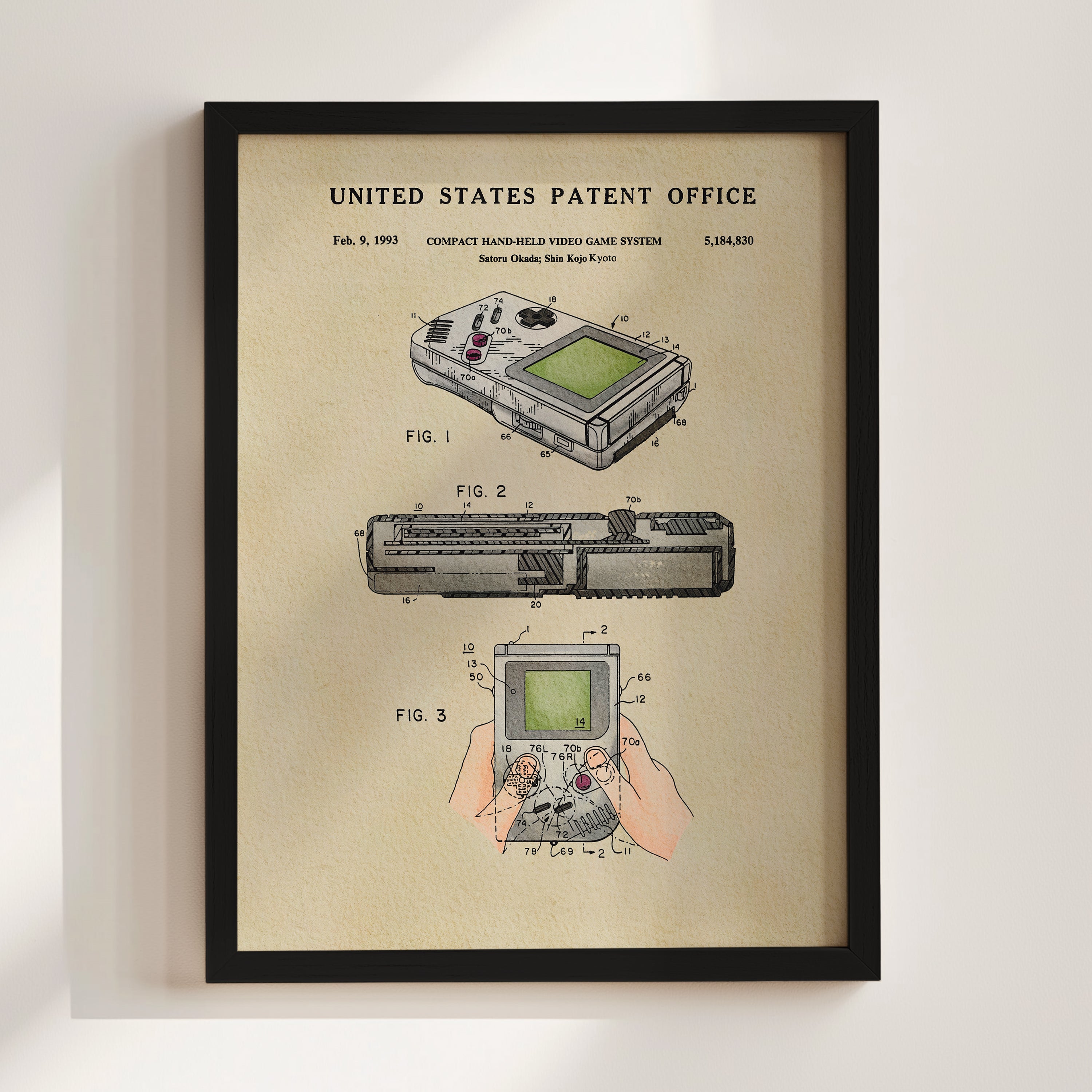 The image is a framed patent illustration depicting a handheld video game system, specifically the Nintendo Gameboy.