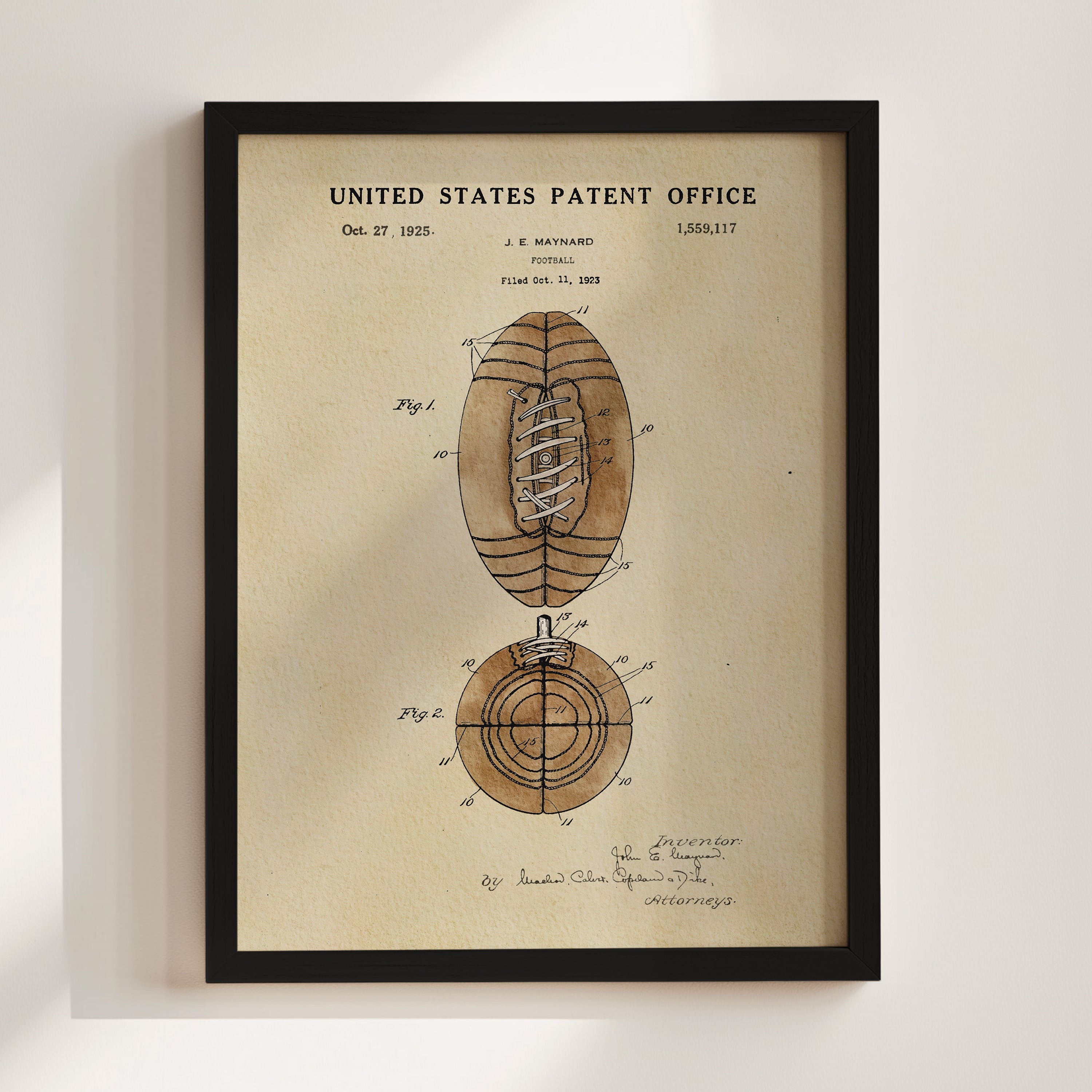 The image is a framed print of a United States patent from 1925, depicting a football with a unique design.