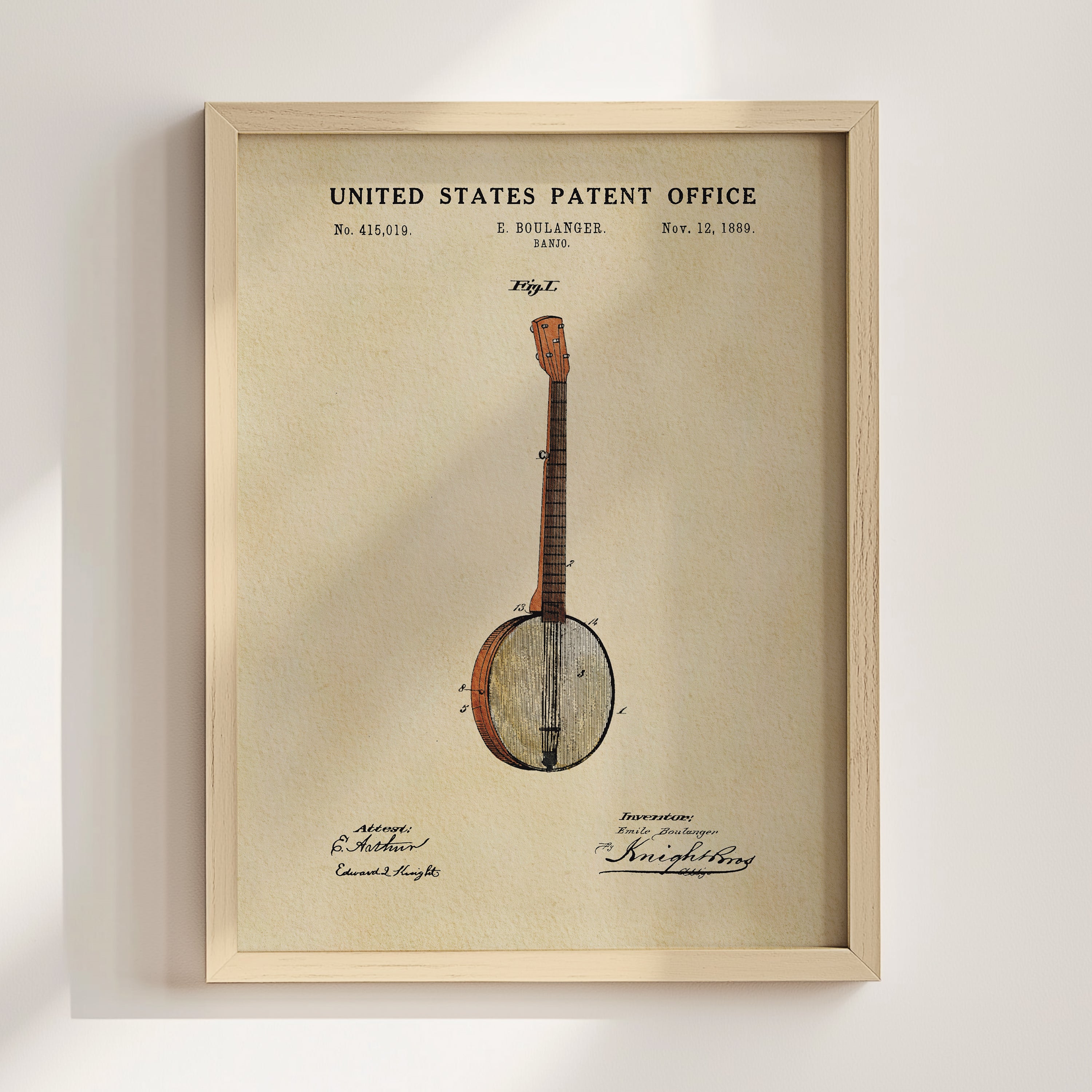 The image is a framed patent drawing of a banjo, depicting the instrument in a detailed and realistic manner.