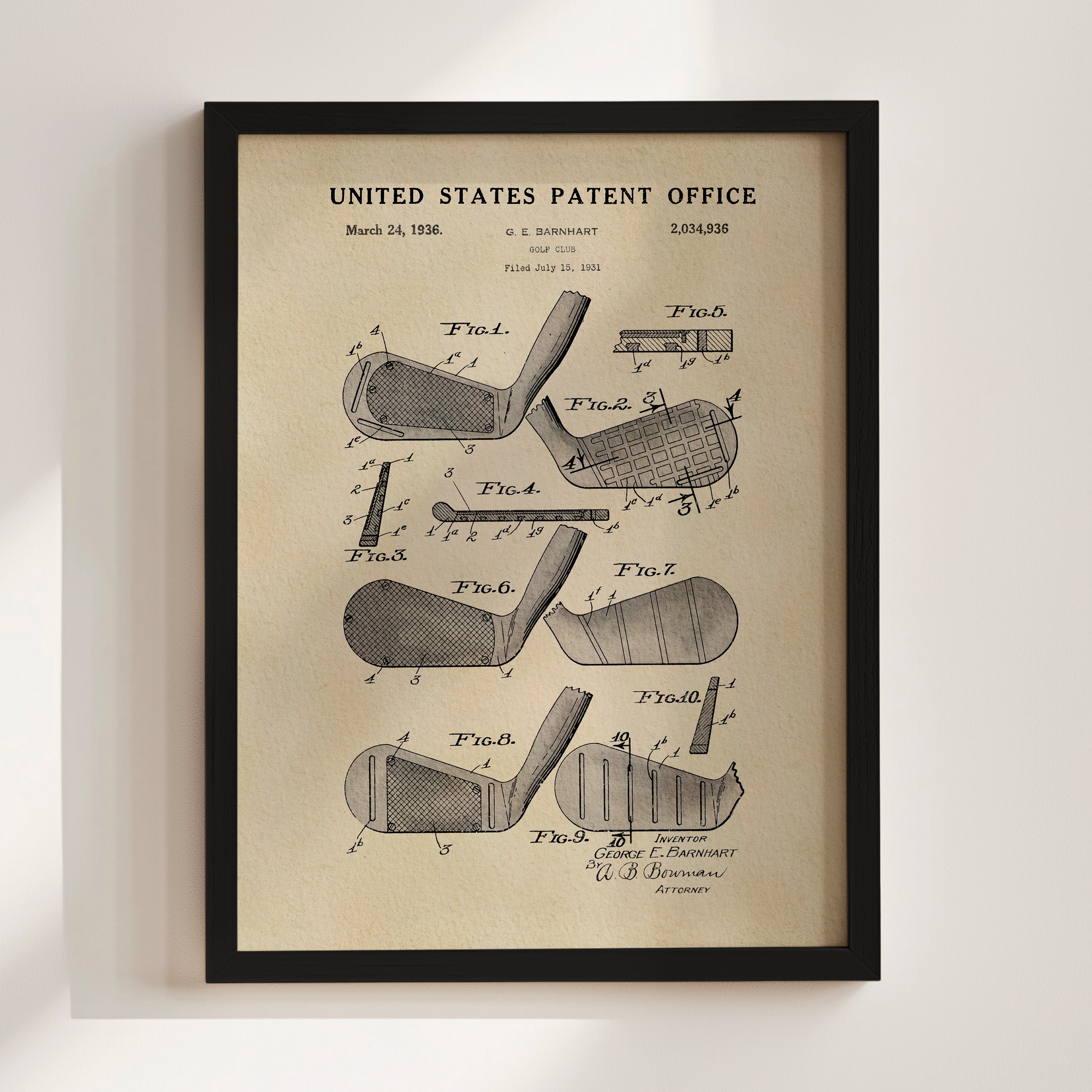The image is a framed vintage patent drawing of a golf club, depicting various parts of the club such as the head, shaft, and grip.