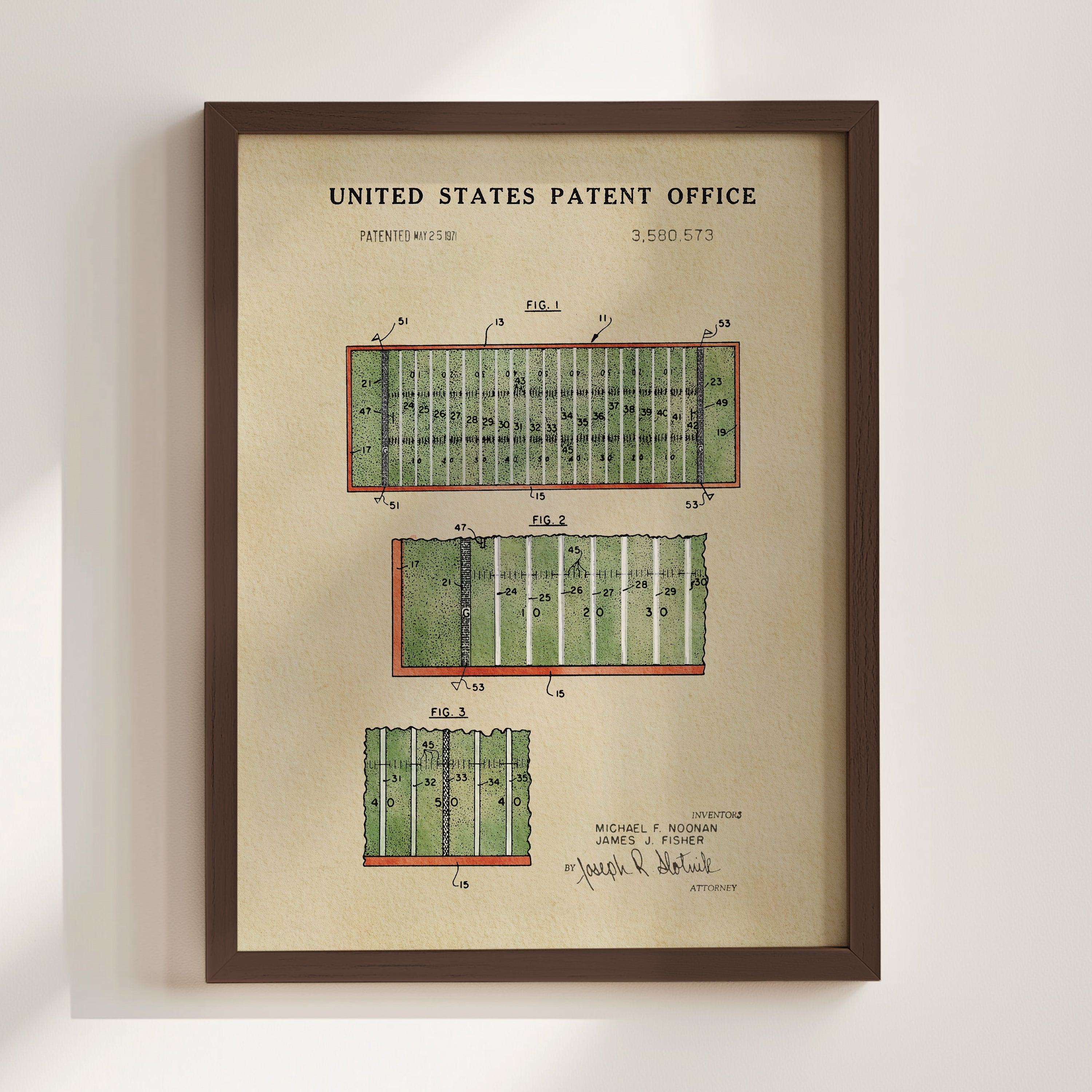 The image is a framed print of a United States patent office patent filing, featuring a detailed illustration of a football field with various markings and dimensions.