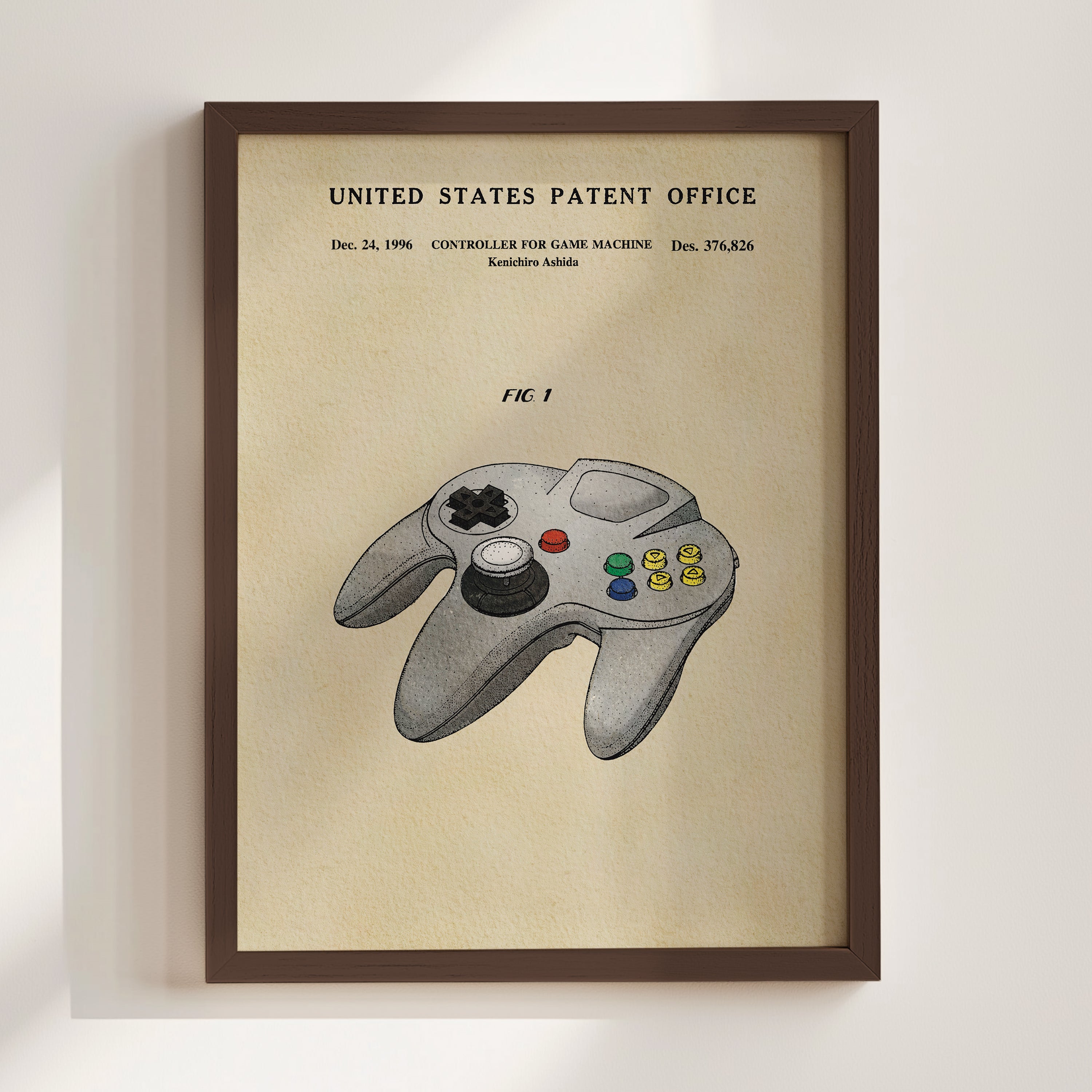 The image is a framed poster or painting depicting a Nintendo 64 game controller, specifically the F1, with the United States Patent Office's patent information displayed above it.