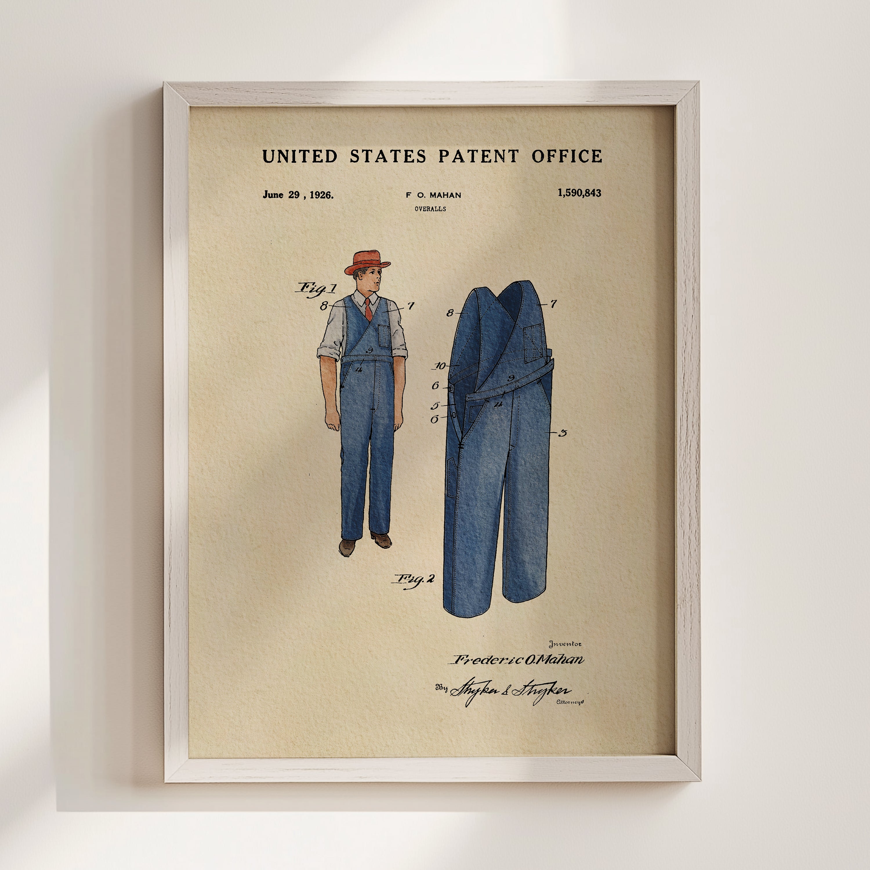 The image is a framed patent drawing depicting a man's outfit, including a hat and a pair of pants.
