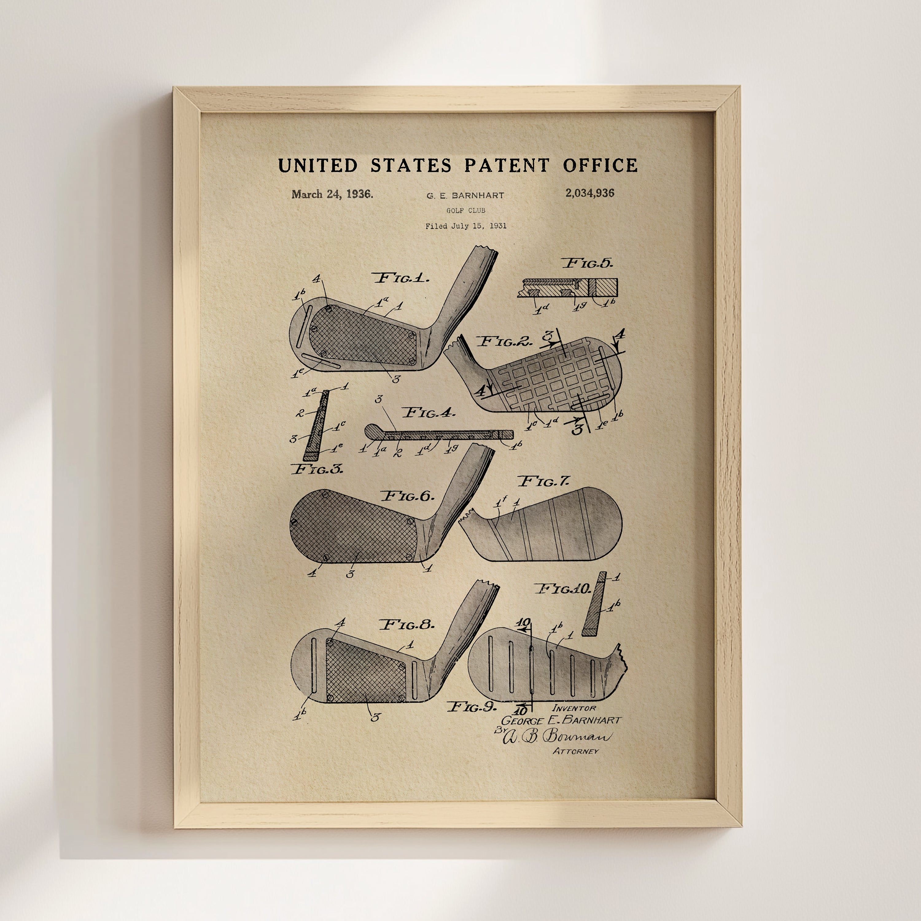 The image is a framed vintage patent drawing of a golf club, depicting various parts of the club such as the head, shaft, and grip.