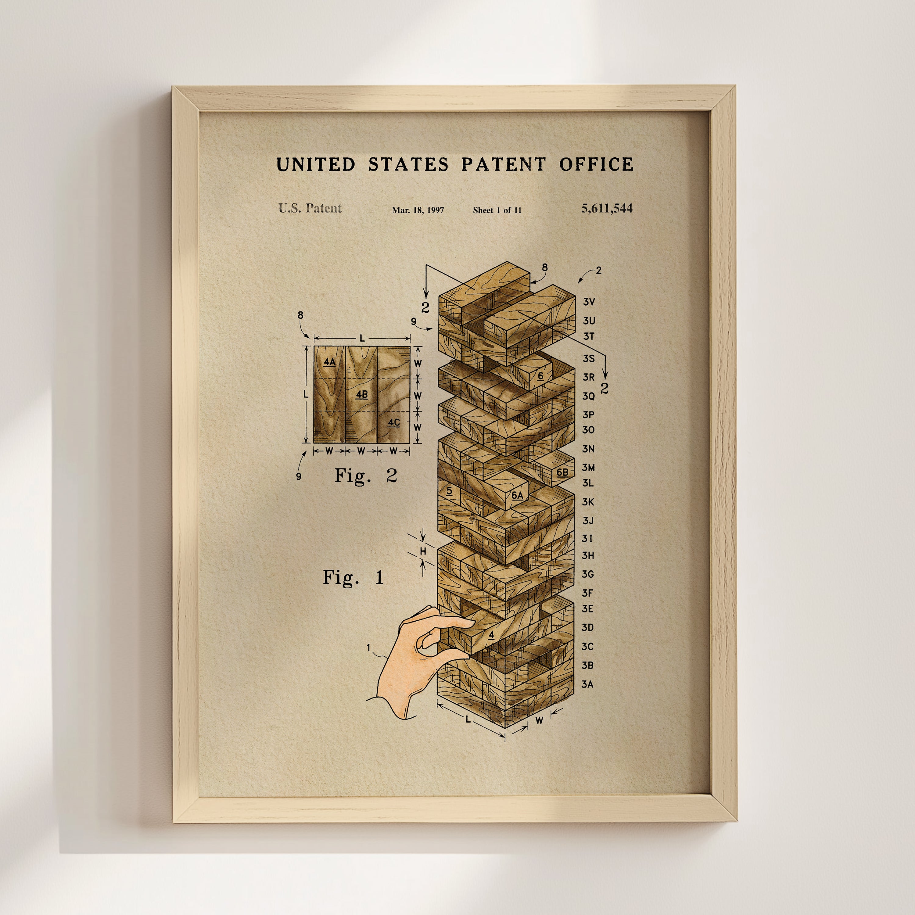 The image is a framed print of a United States patent office patent from 1997, depicting a Jenga block tower.