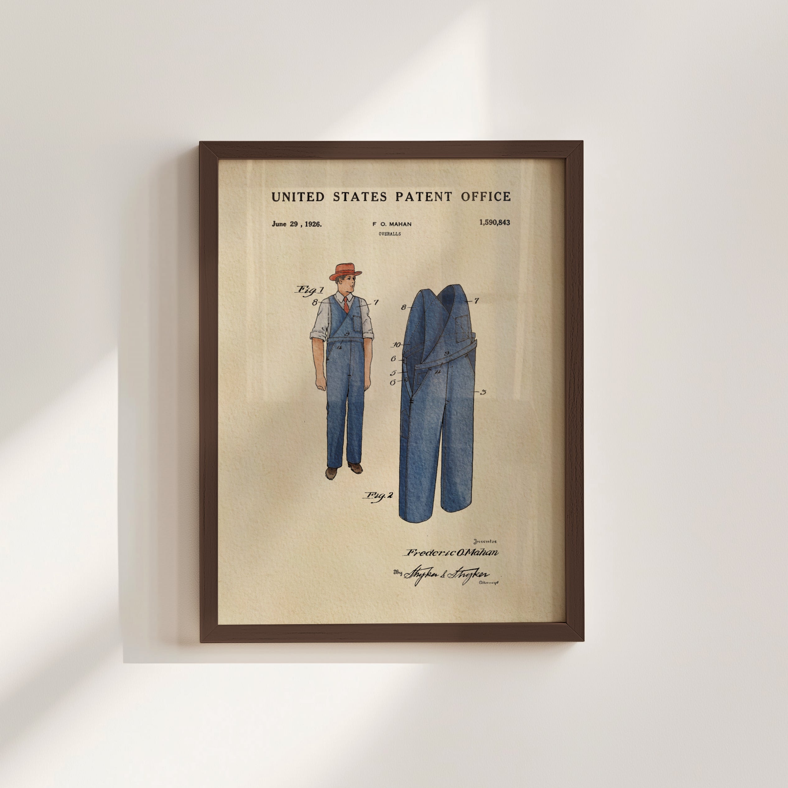 The image is a framed patent drawing depicting a man's outfit, including a hat and overalls, with a focus on the design and construction of the clothing.