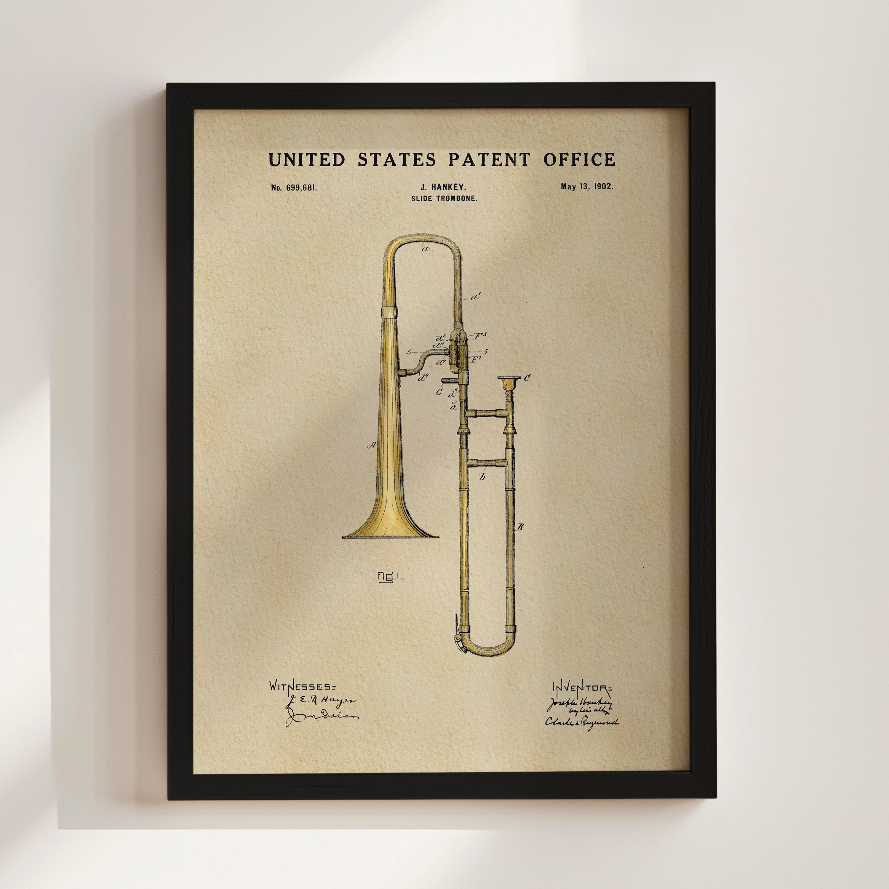 The image is a framed print of a United States patent office patent from May 13, 1902, depicting a slide trumpet.