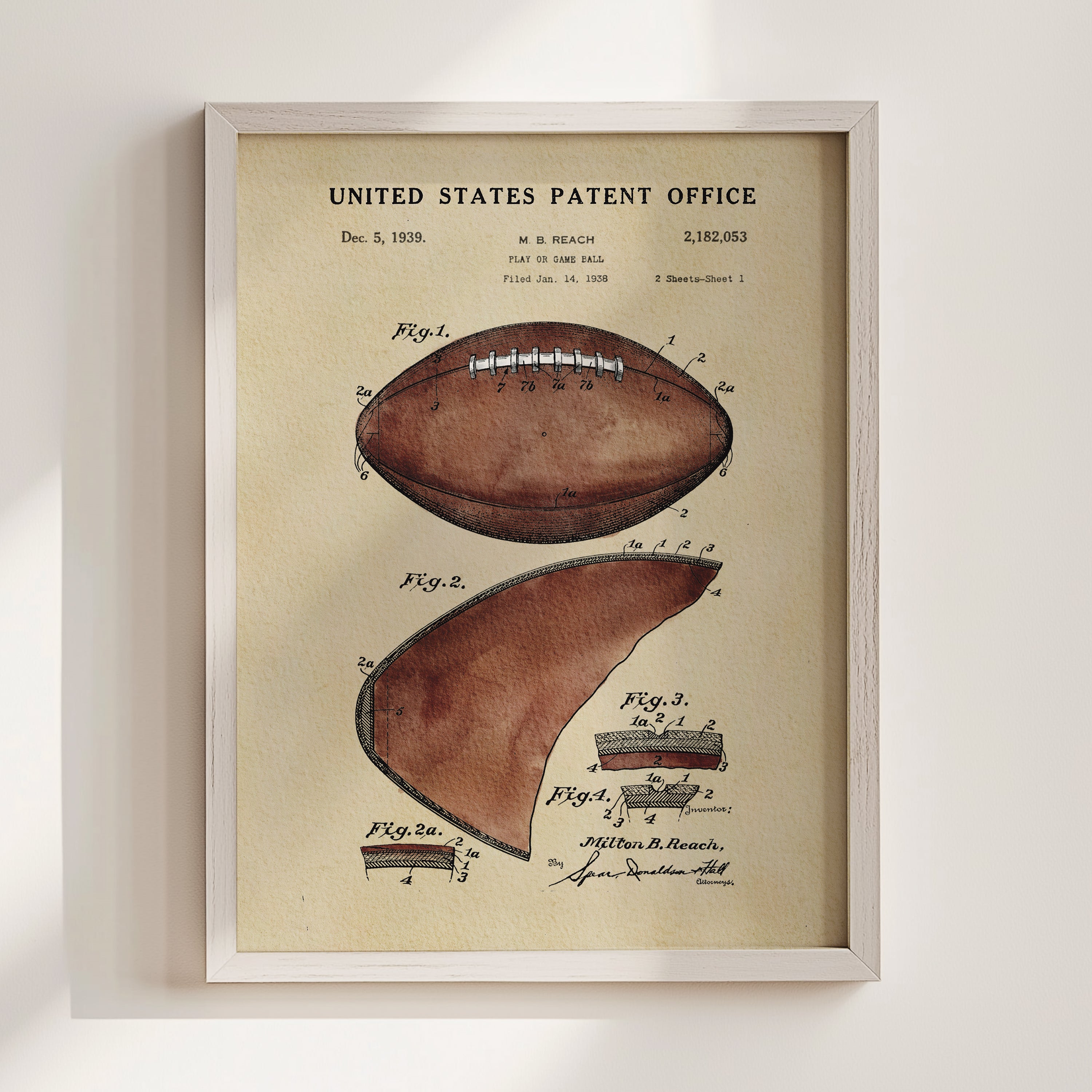 The image is a framed vintage patent drawing of a football, depicting the design and features of the ball.