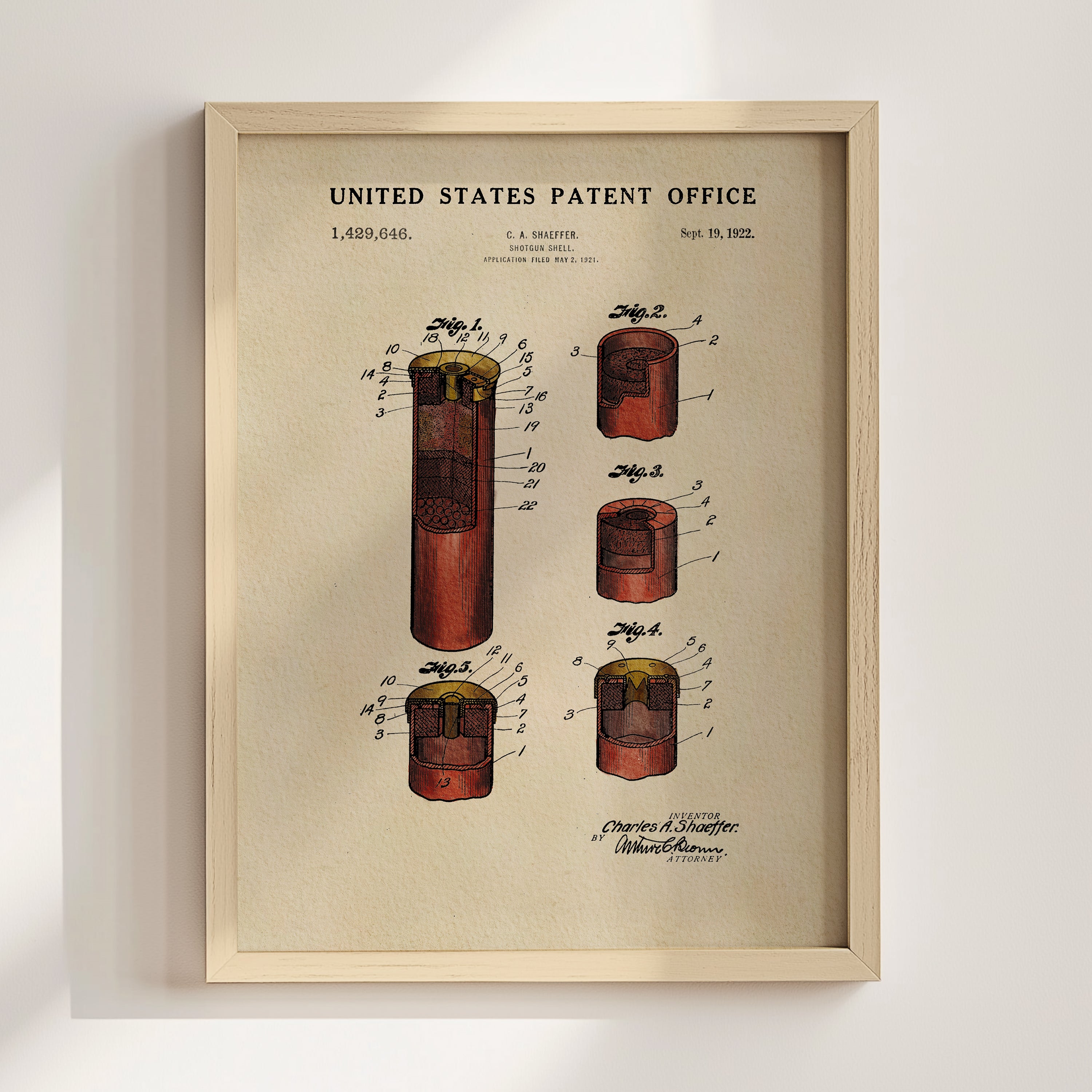 The image is a framed patent drawing depicting a device with multiple components, including a red cylinder, a yellow cylinder, and a red cylinder.