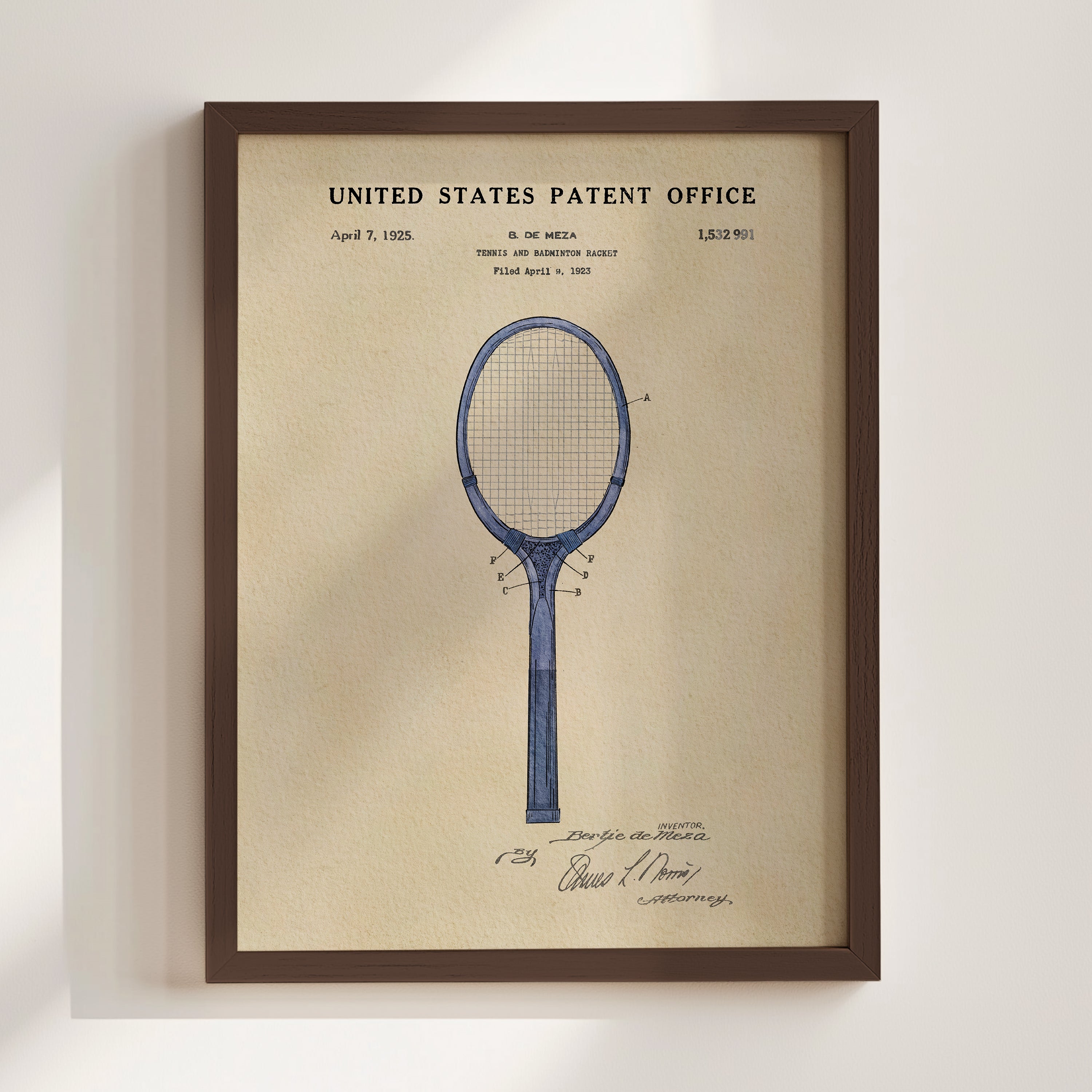 The image is a framed print of a blue tennis racket with a patent registration from the United States Patent Office dated April 9, 1925.