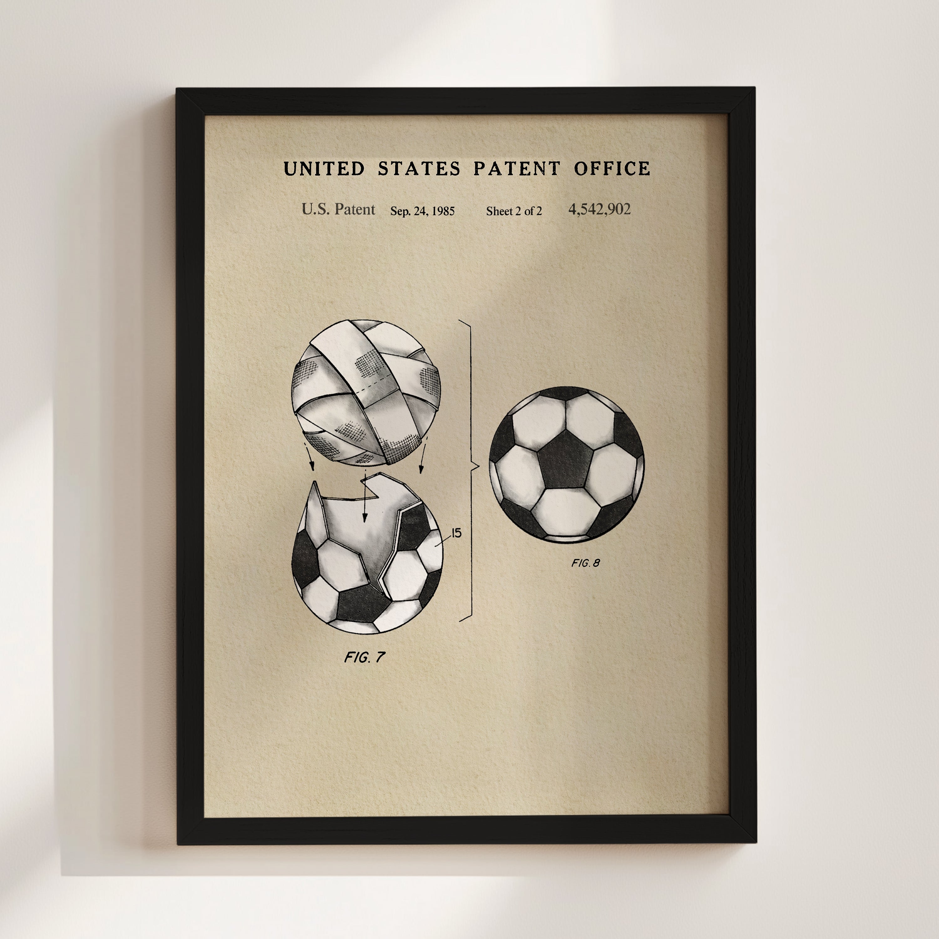 The image is a framed print depicting a soccer ball with a tear, along with two other soccer balls.
