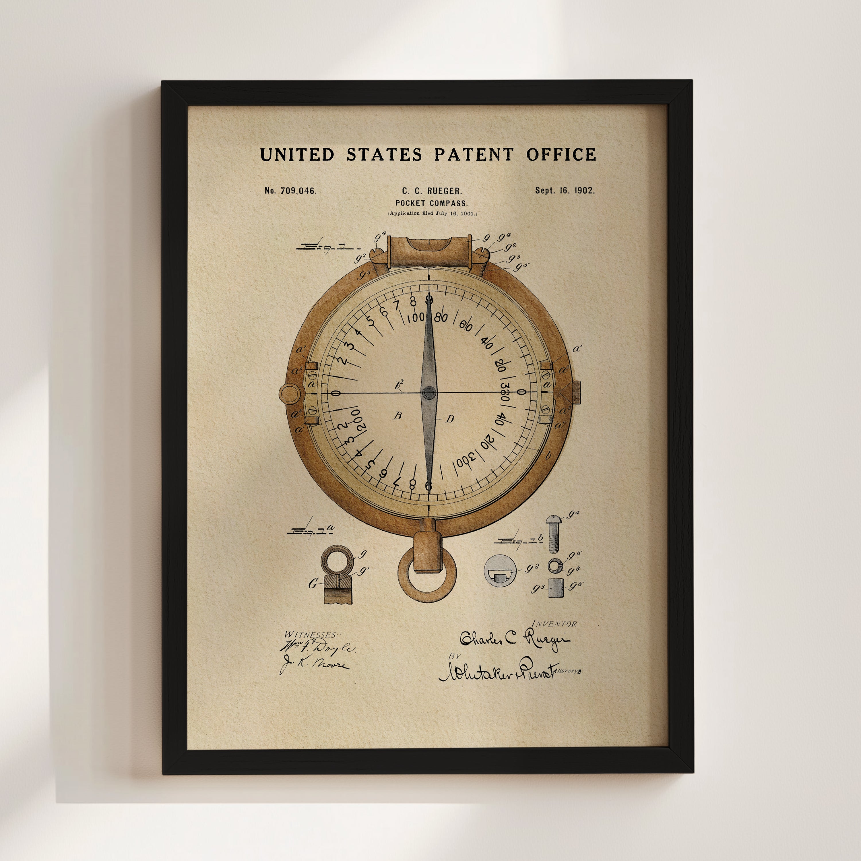 The image is a framed patent drawing of a compass, depicting the United States Patent Office from September 18, 1902.