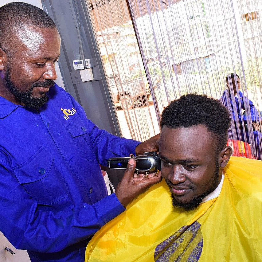 A barber trimming hair with clippers