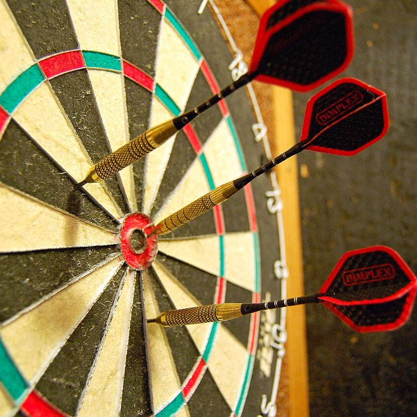 Darts in a dartboard bullseye
