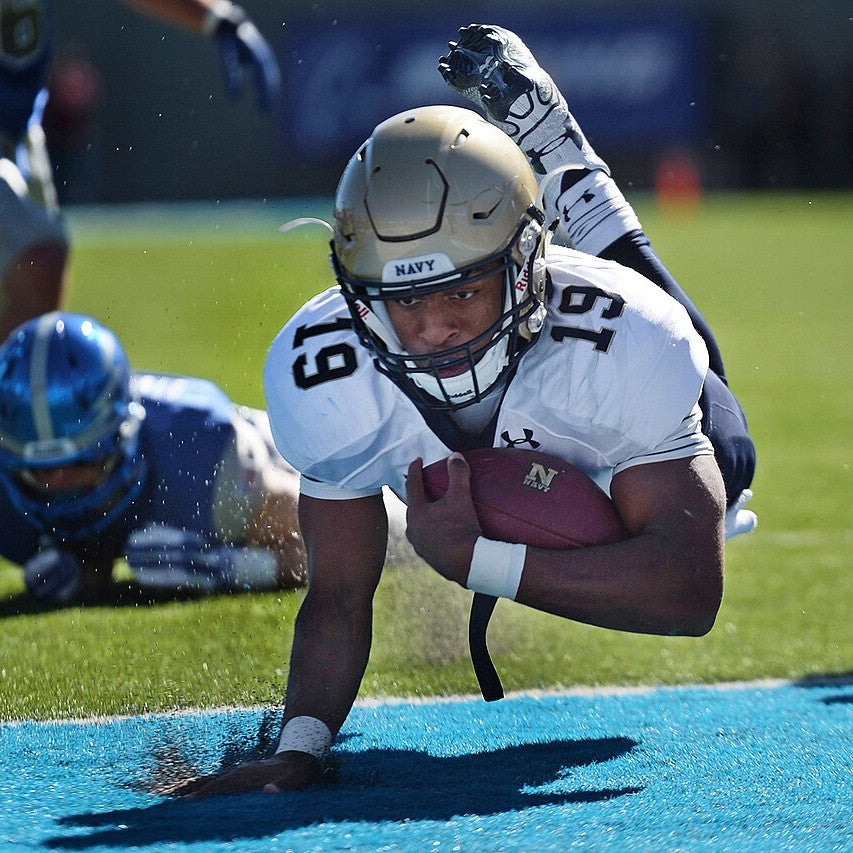 A football player diving for a touchdown