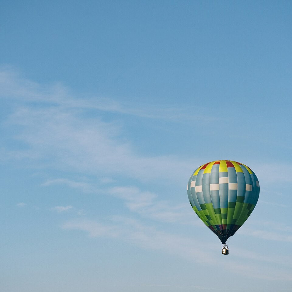 A colorful hot air balloon in a blue sky
