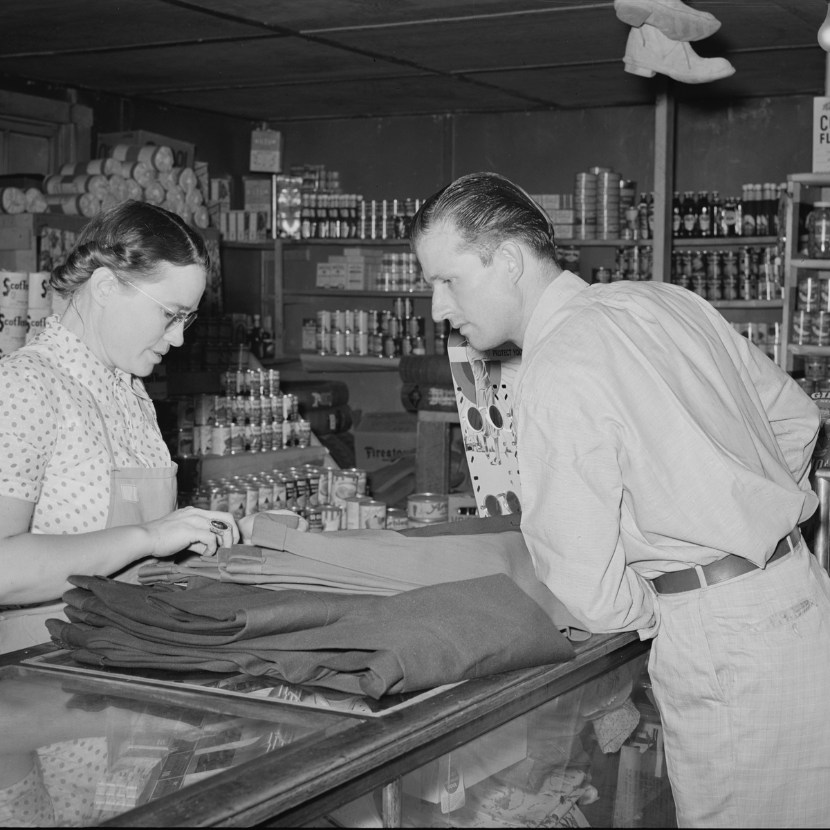 Clerk and customer at a general store counter, 1940