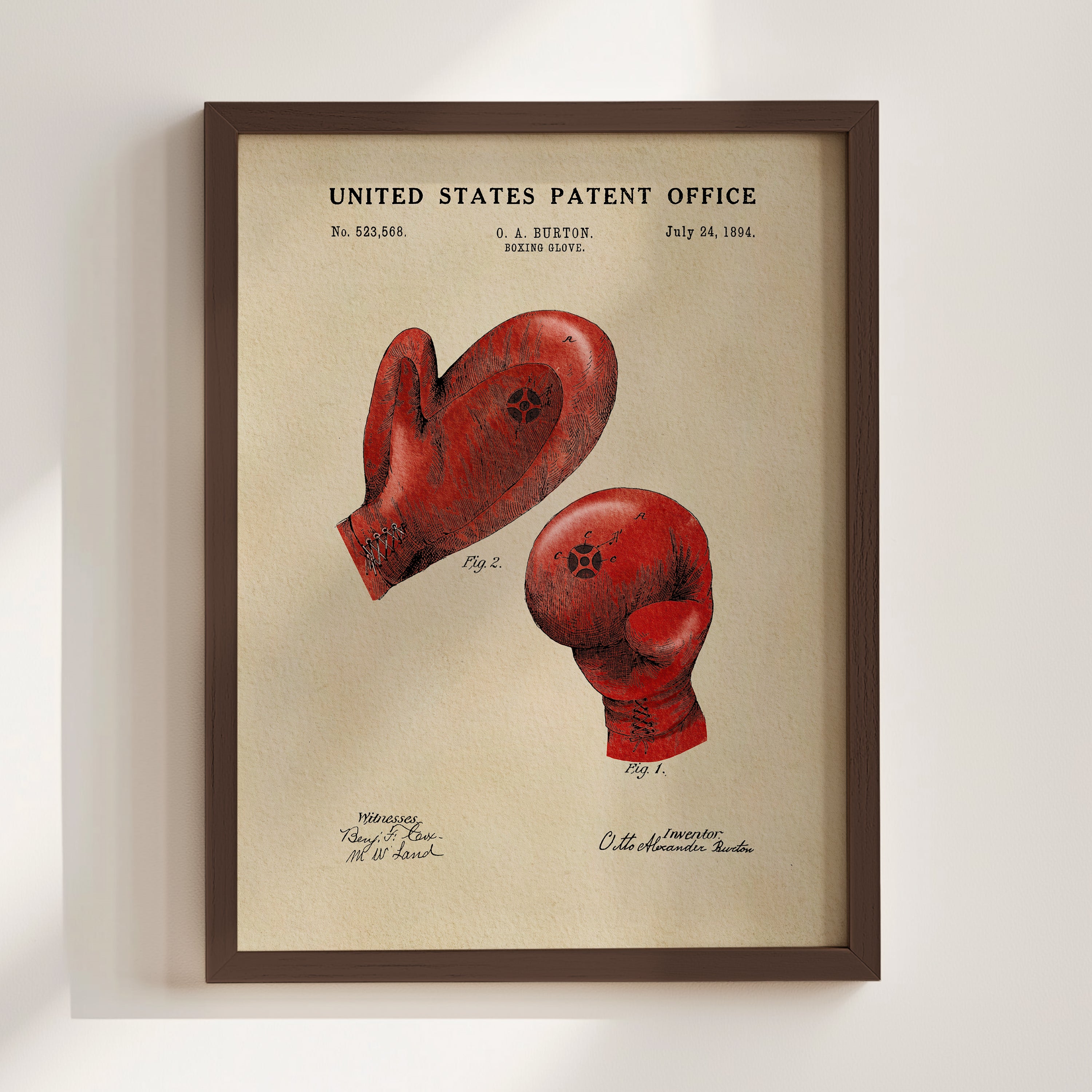 The image is a framed print of a red boxing glove with a patent application from the United States Patent Office dated July 24, 1884.