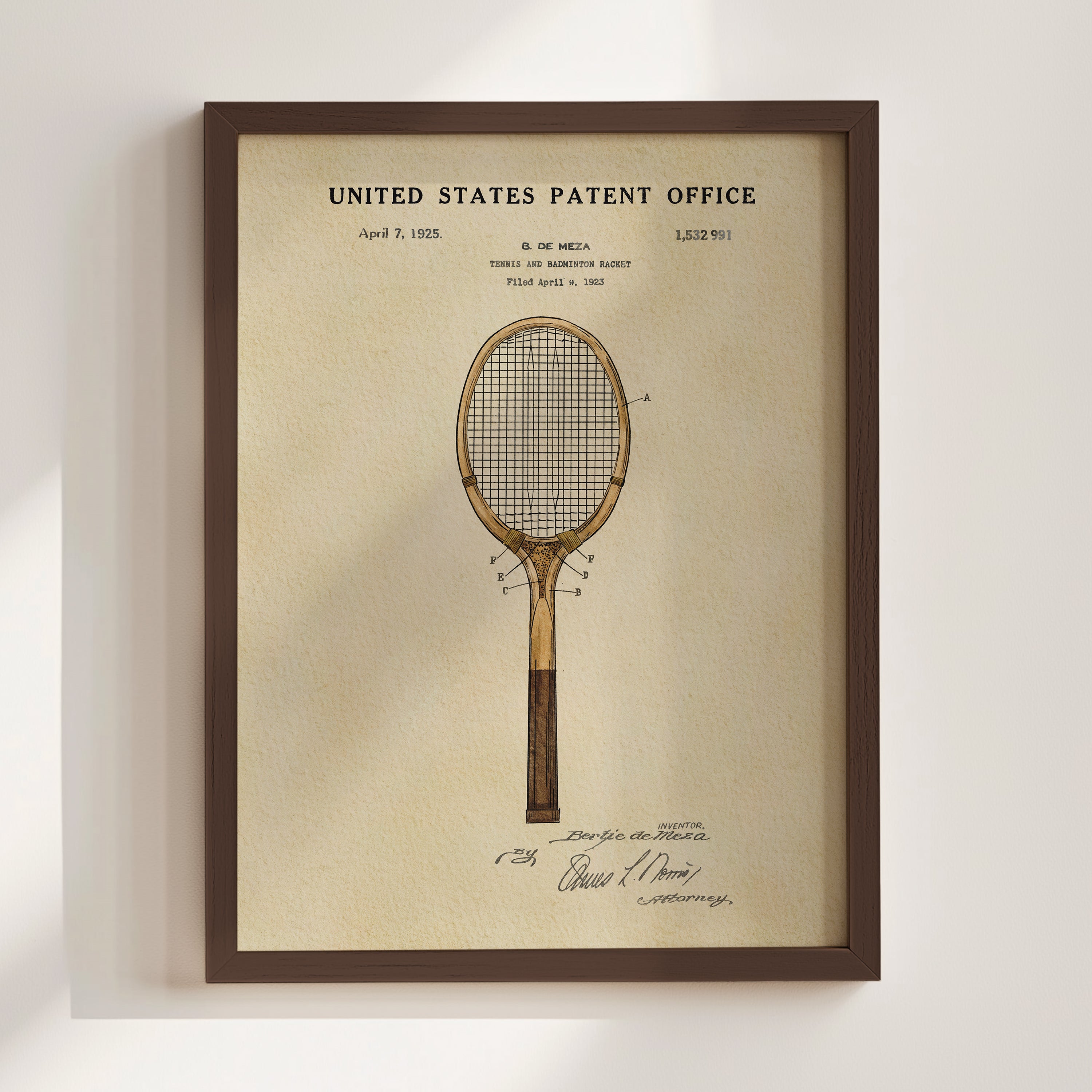 The image is a framed vintage patent drawing of a tennis racket, depicting a design from the early 20th century.