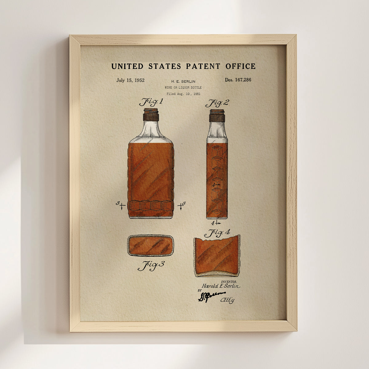 The image is a framed print of a United States patent office patent from July 15, 1952, depicting a bottle of whiskey.