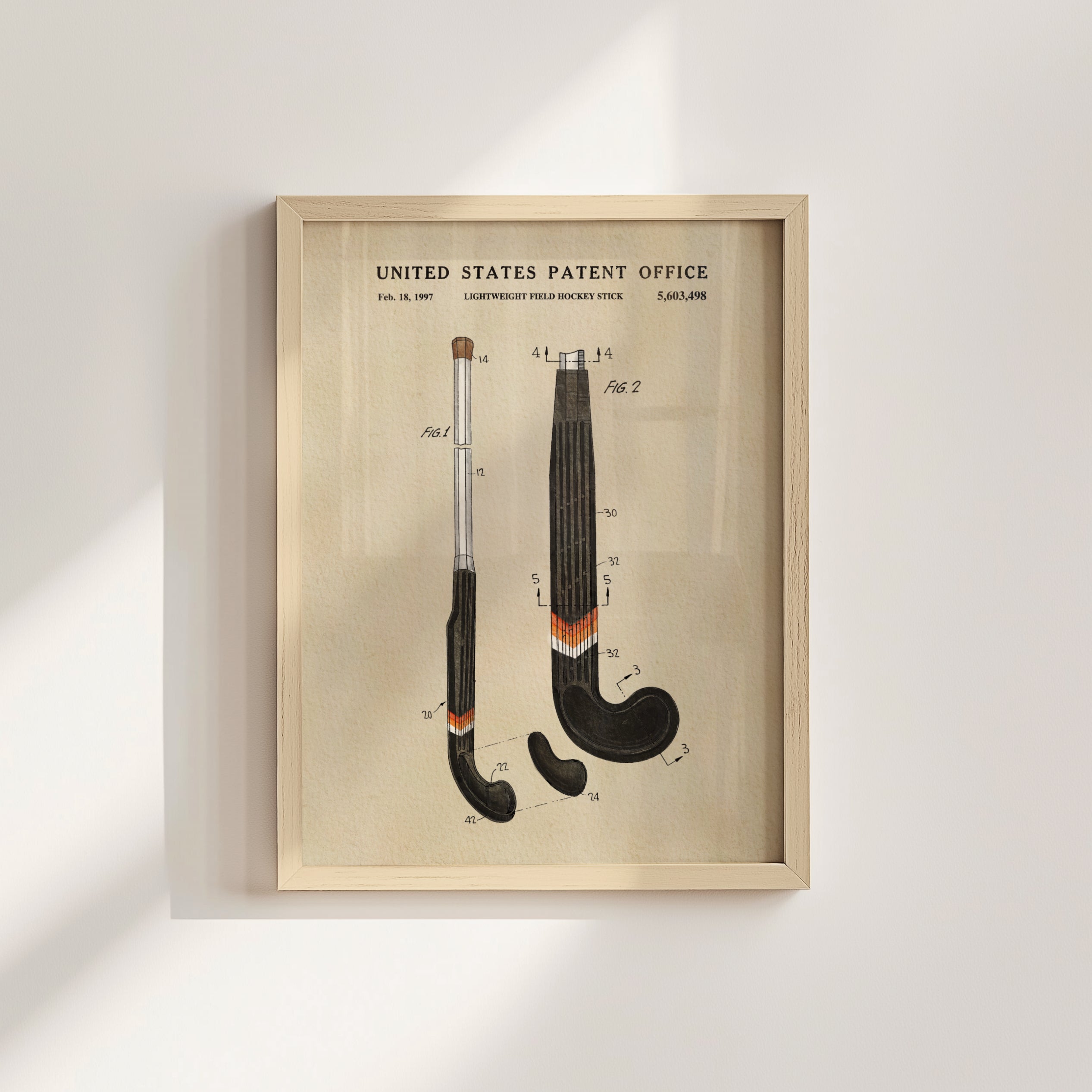 The image is a framed patent drawing depicting two hockey sticks with detailed technical drawings and labels.