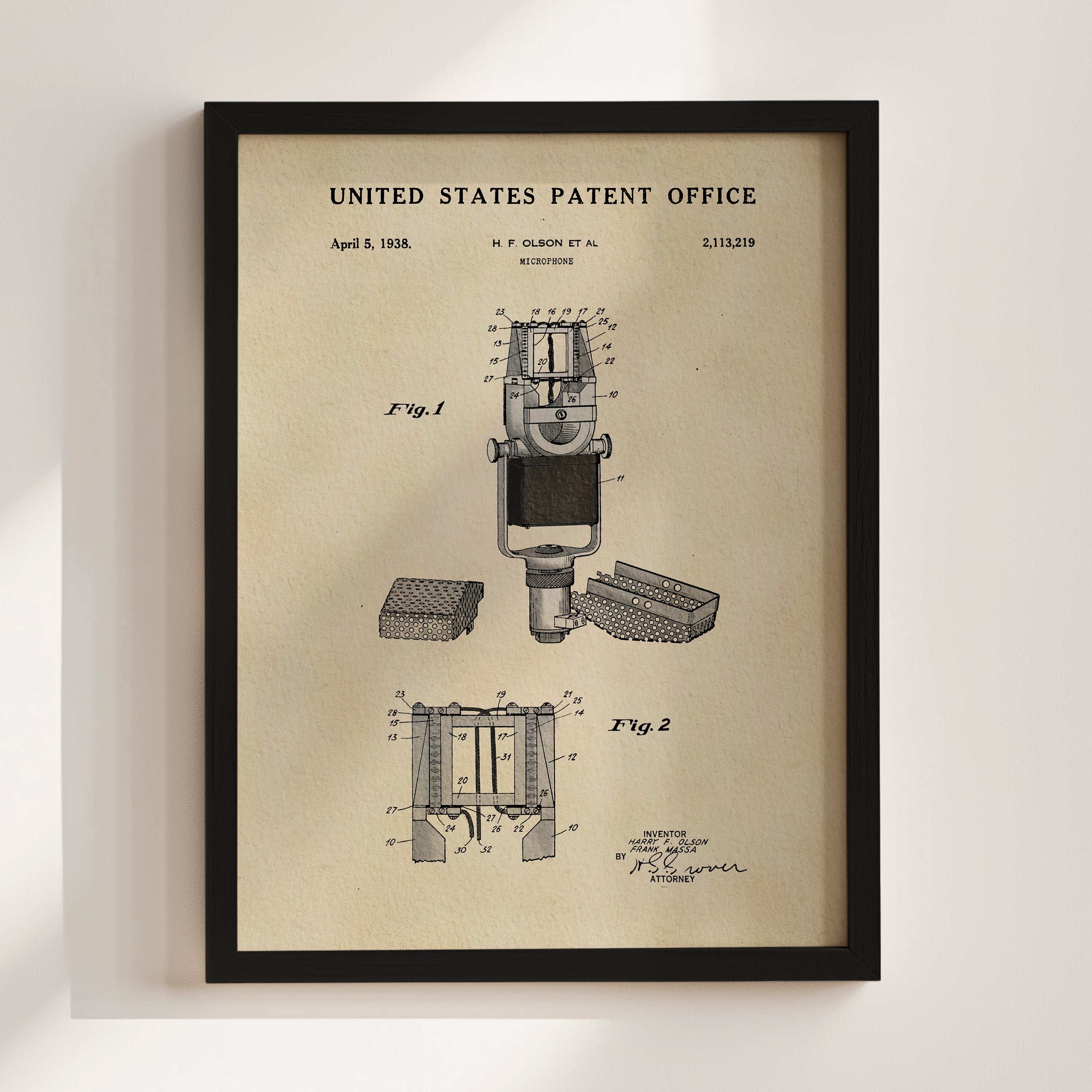 The image is a framed vintage patent drawing of a microphone, depicting the design and features of the device.