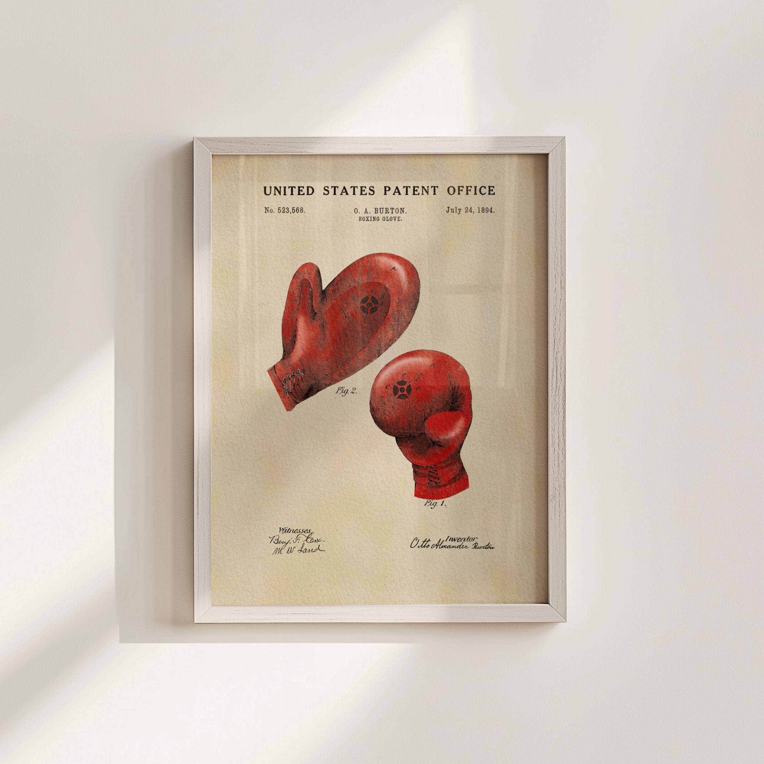 The image is a framed print of a red boxing glove with a patent application from the United States Patent Office dated July 24, 1884.