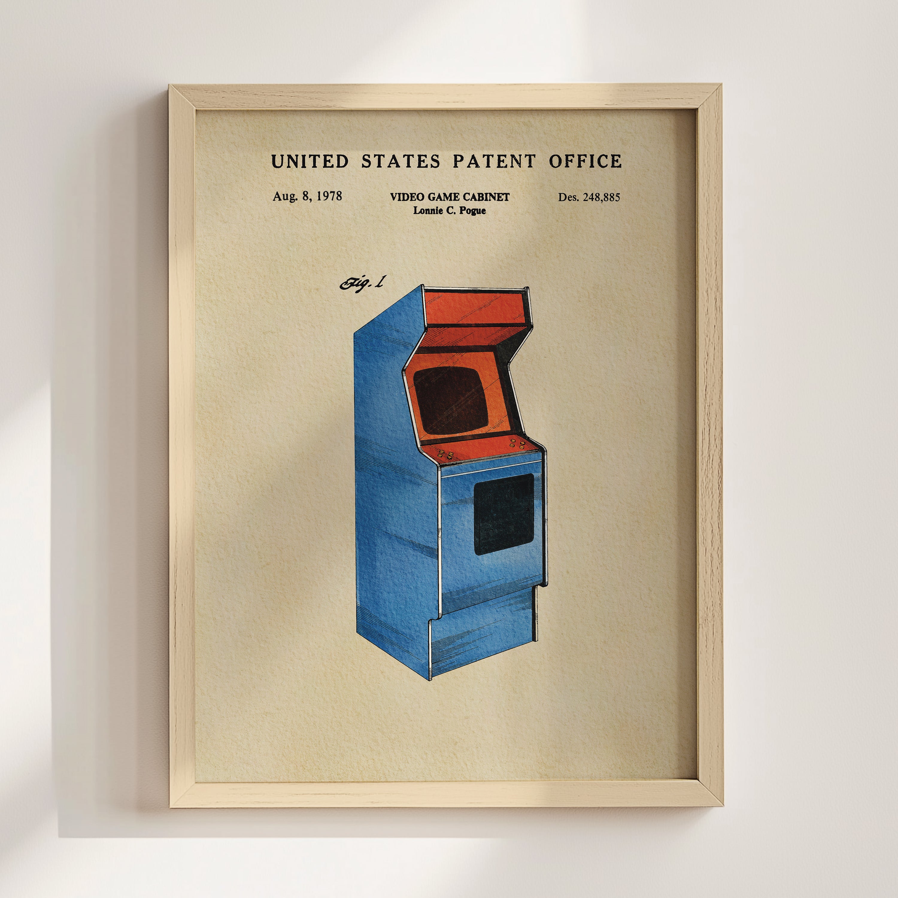 The image is a framed poster depicting a blue arcade cabinet with an orange screen, which is a vintage video game cabinet patent from the United States.