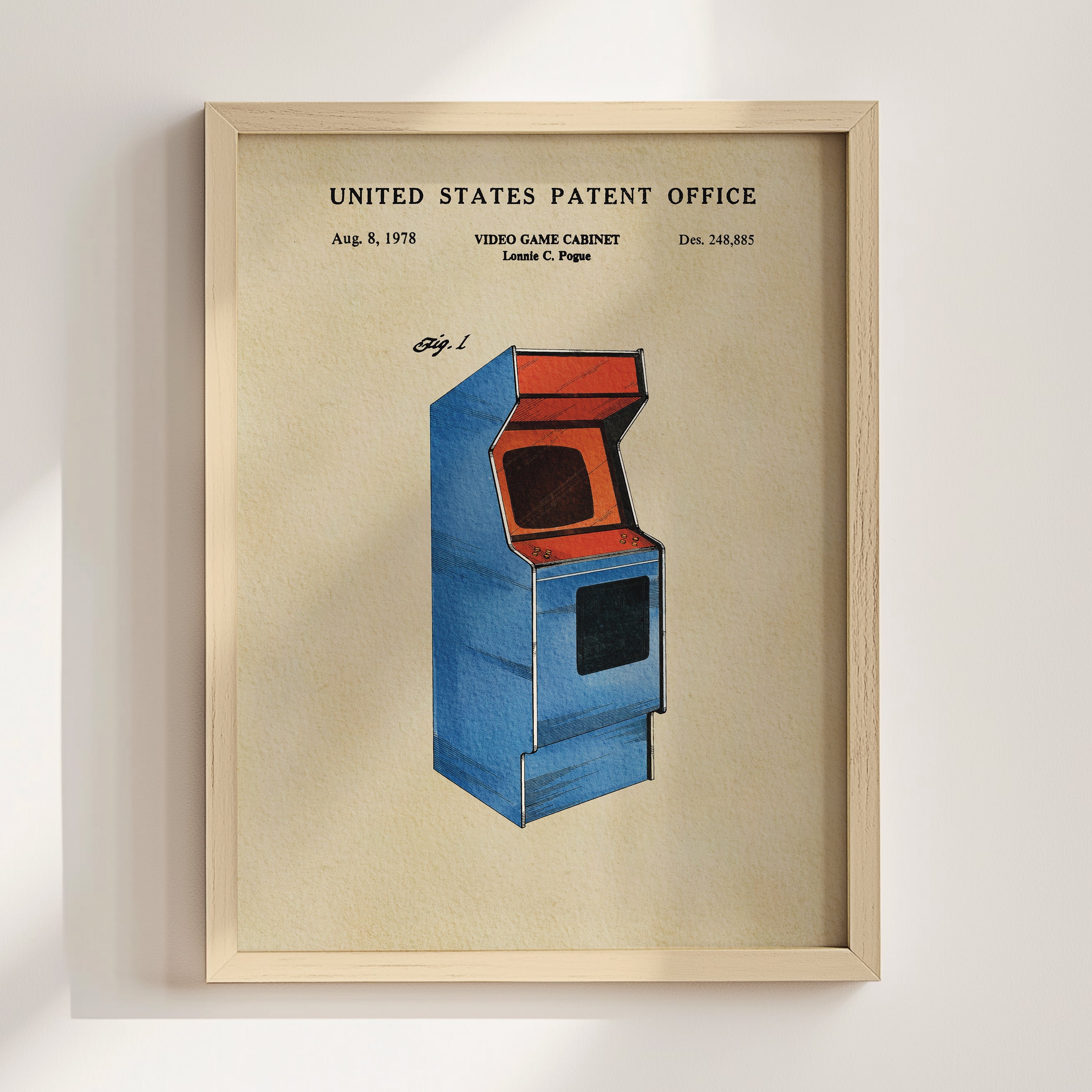 The image is a framed poster depicting a blue arcade cabinet with an orange screen, which is a vintage video game cabinet patent from the United States.