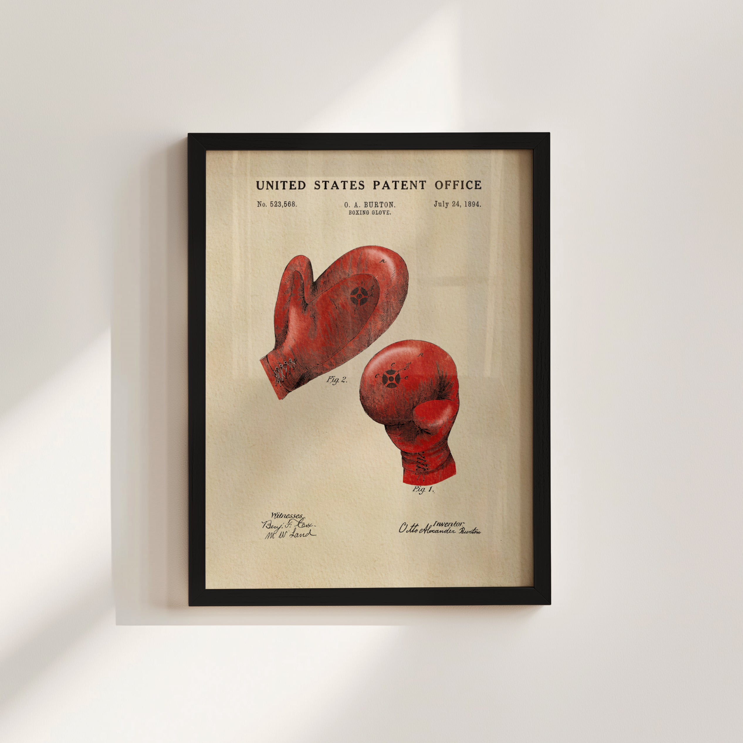 The image is a framed patent drawing depicting two red boxing gloves, with the United States Patent Office's patent filing details visible.
