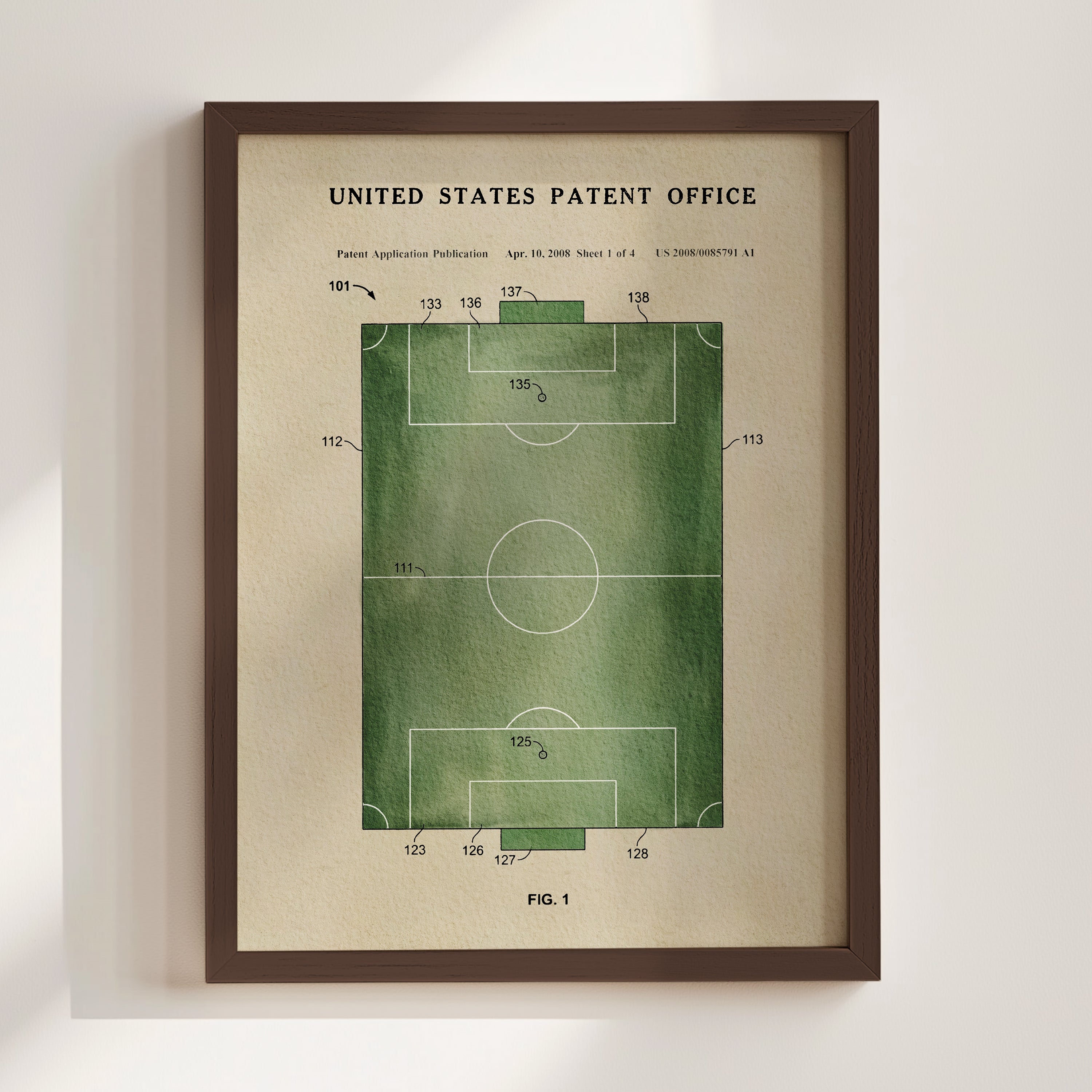 The image is a framed print depicting a patent application for a soccer field, with a green field and white markings.