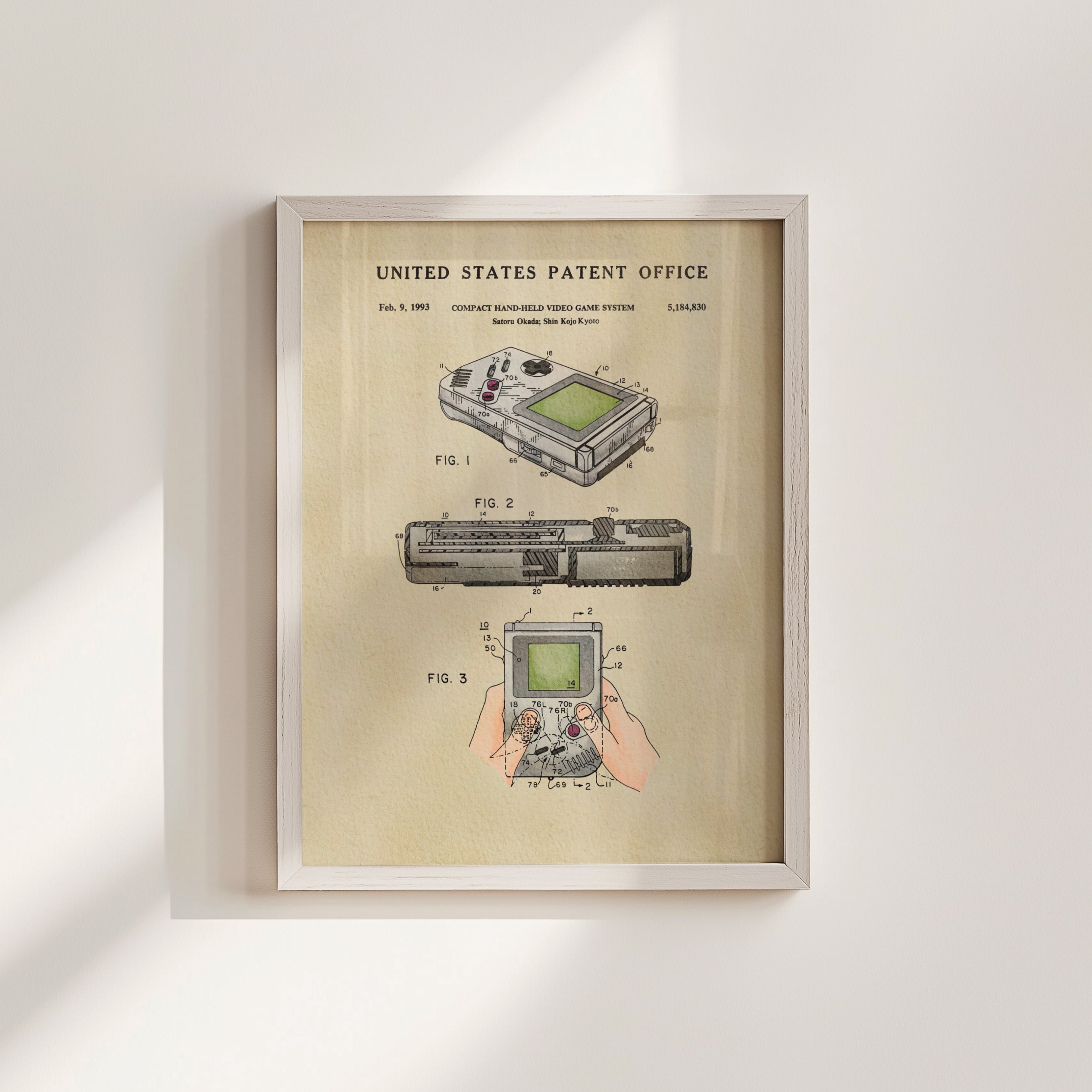 The image is a framed patent illustration depicting the design of a handheld video game system, specifically the Nintendo GameCube.