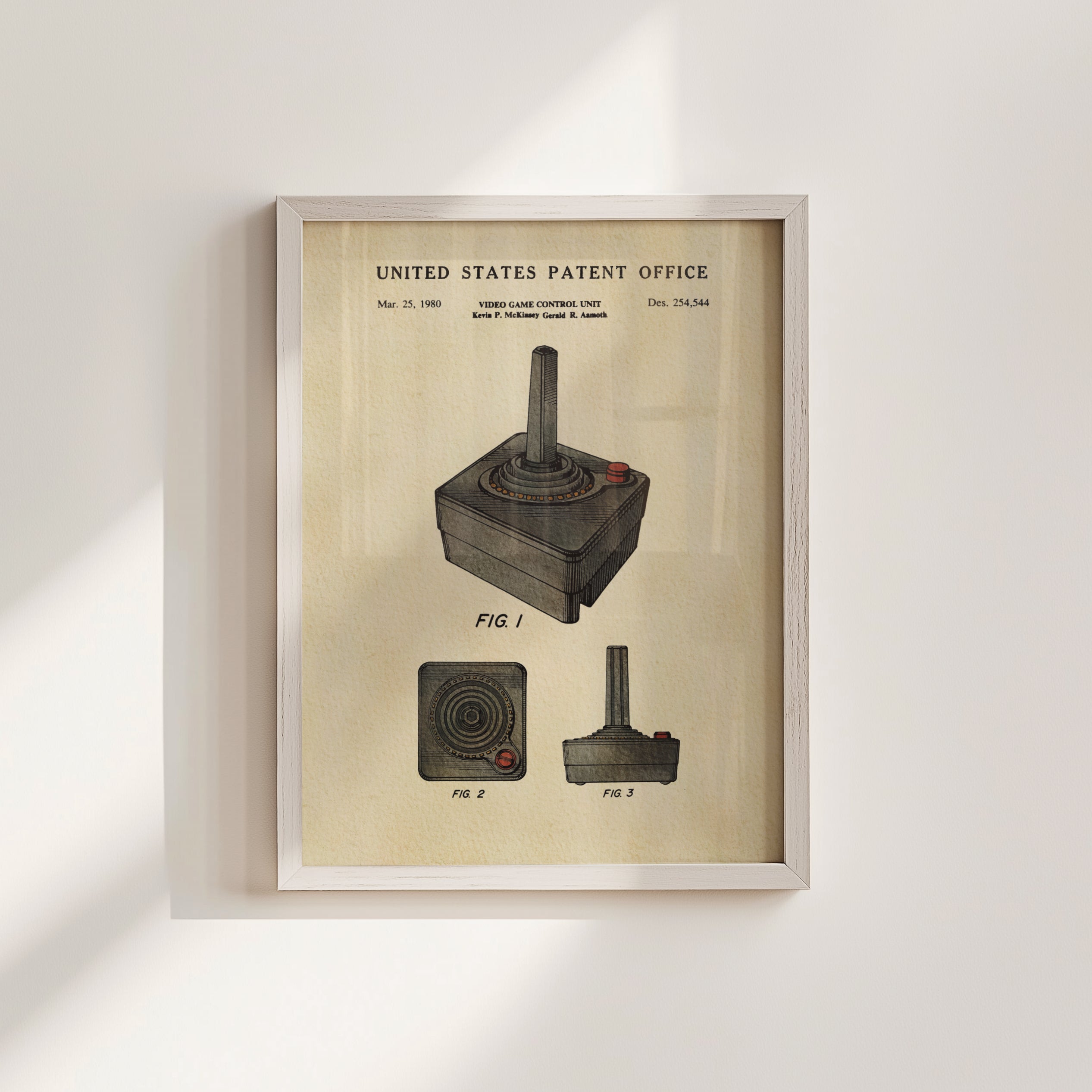 The image is a framed vintage patent drawing of a joystick, depicting the controls and features of the joystick in a framed artwork.