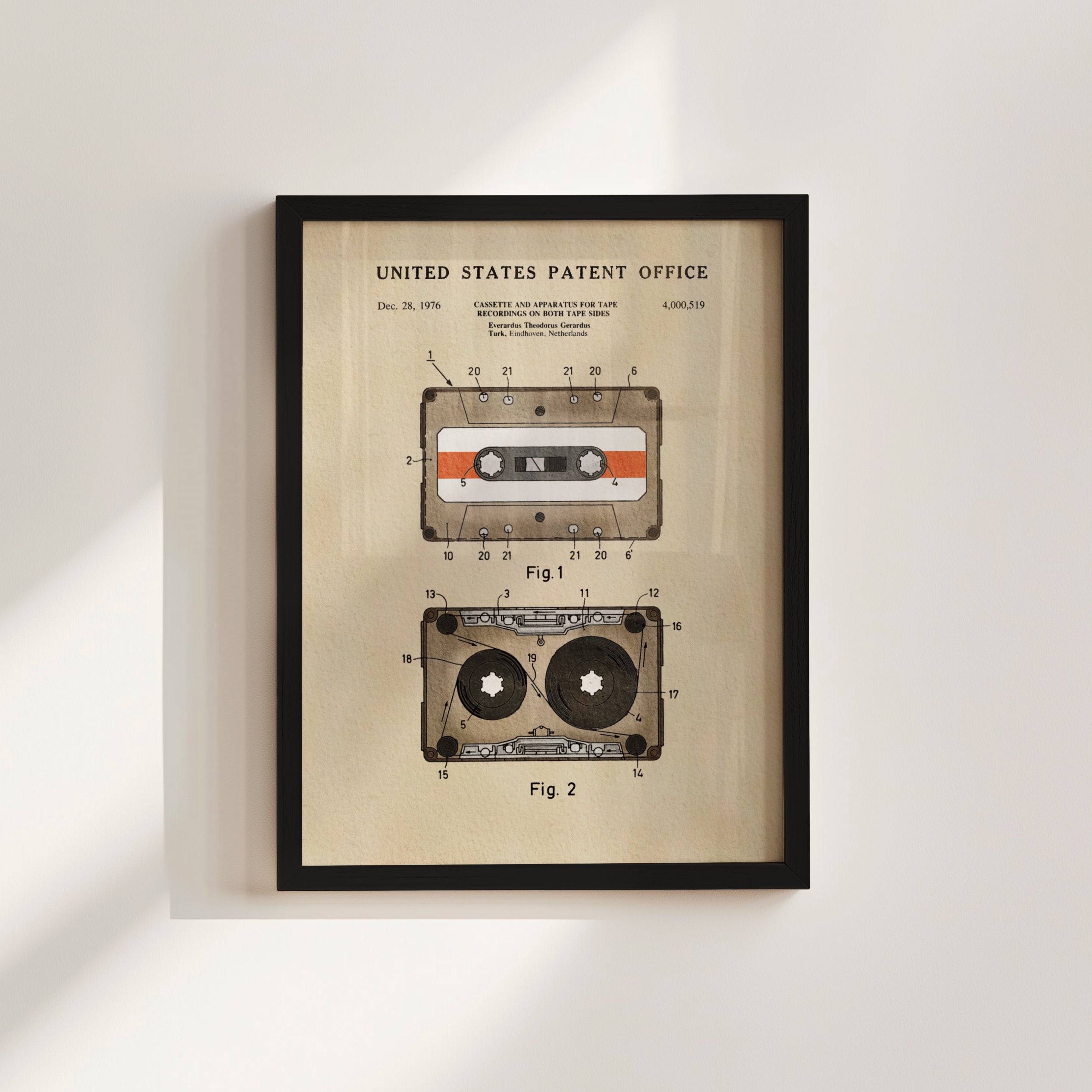 The image is a framed patent drawing depicting a cassette tape and a tape recorder, both with a vintage design.
