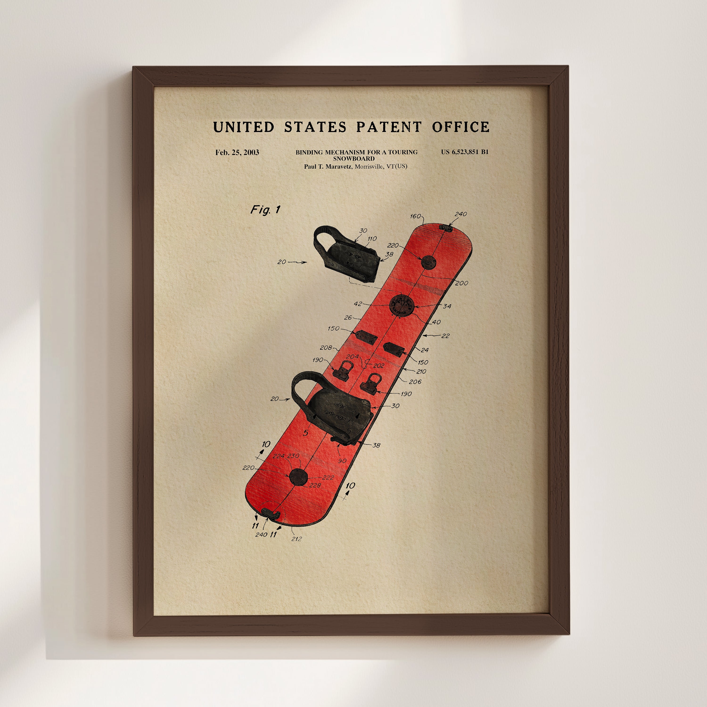 The image is a framed patent drawing of a red snowboard with various technical drawings and specifications.