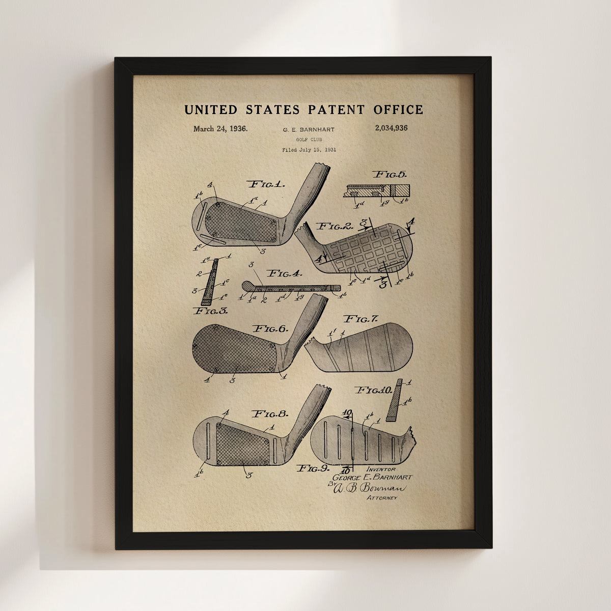 The image is a framed vintage patent drawing of a golf club, depicting various parts of the club such as the head, shaft, and grip.