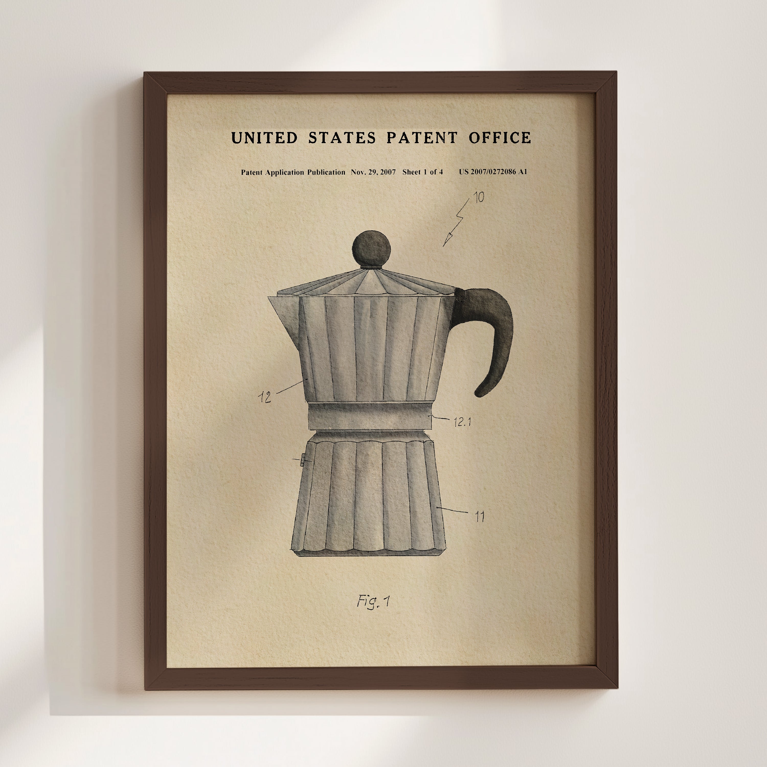 The image is a framed vintage patent drawing of a coffee maker, depicting the design and features of the device.