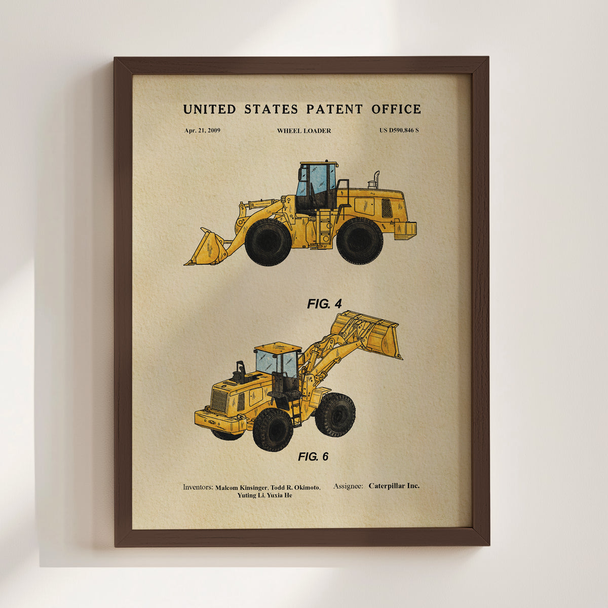 The image is a framed poster featuring two illustrations of wheel loaders, one labeled "FIG. 4" and the other "FIG. 6". The poster is titled "UNITED STATES PATENT OFFICE" and includes the text "wheeled loader" and "U.S. Patent 8,539,844 S".
