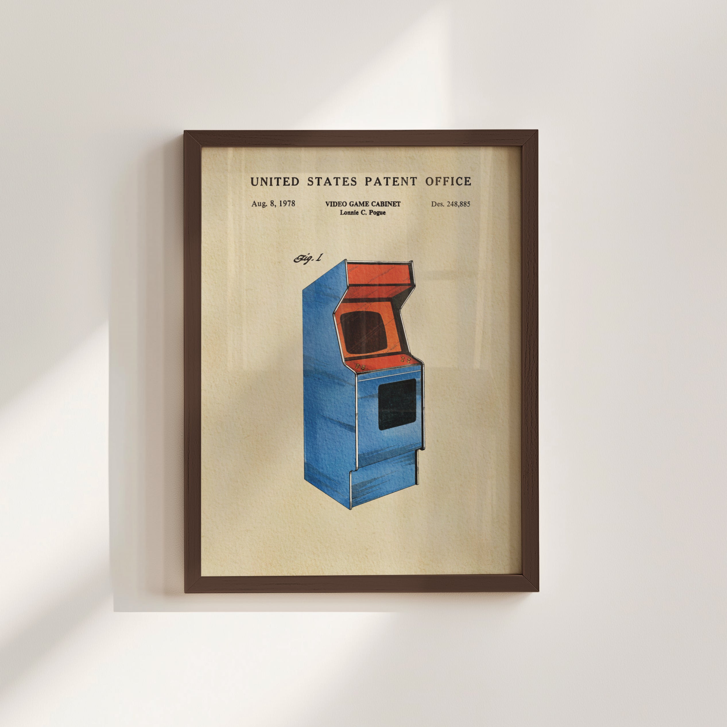 The image is a framed patent drawing of a blue arcade cabinet, depicting a retro gaming console from the 1980s.