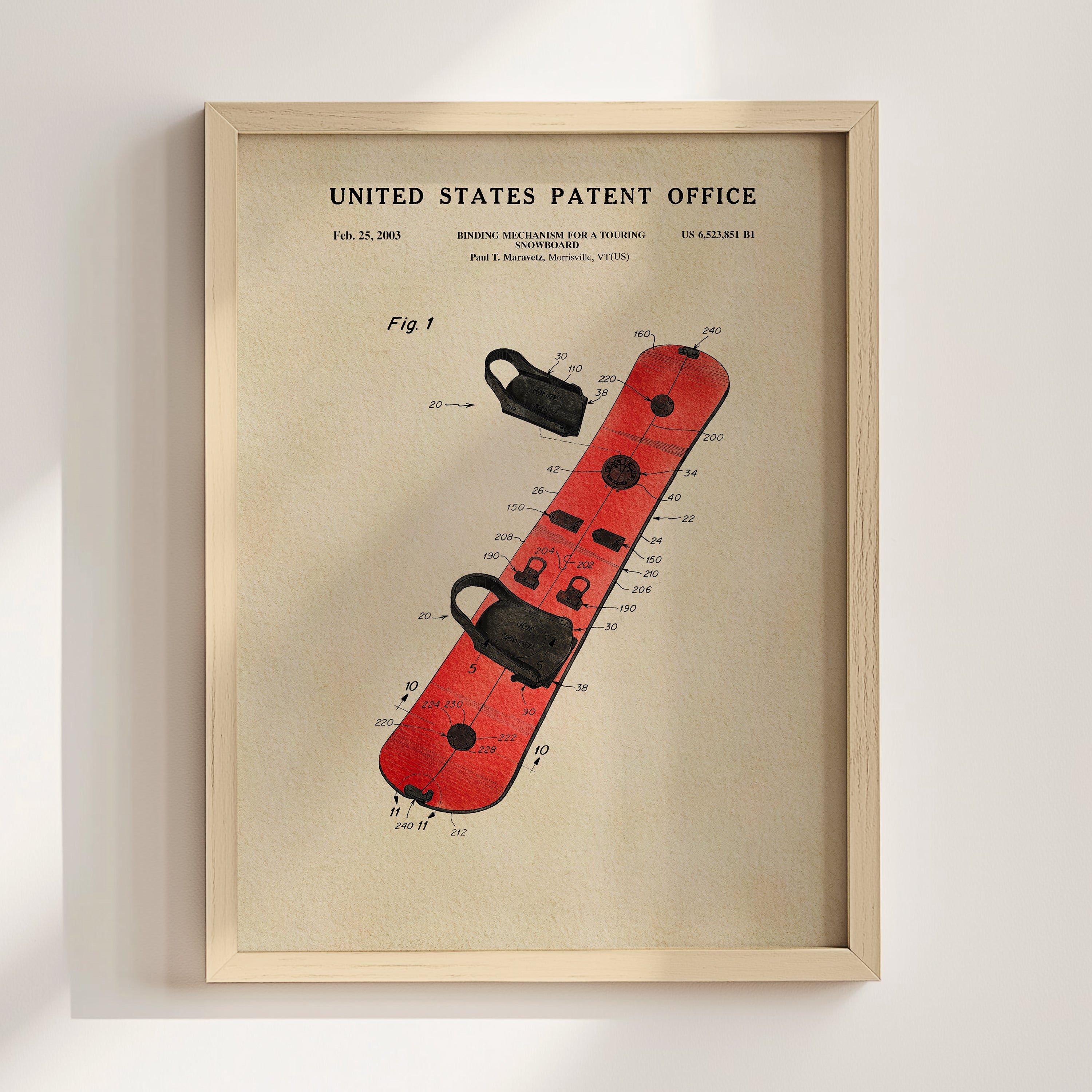The image is a framed patent drawing of a red snowboard with various technical drawings and specifications.